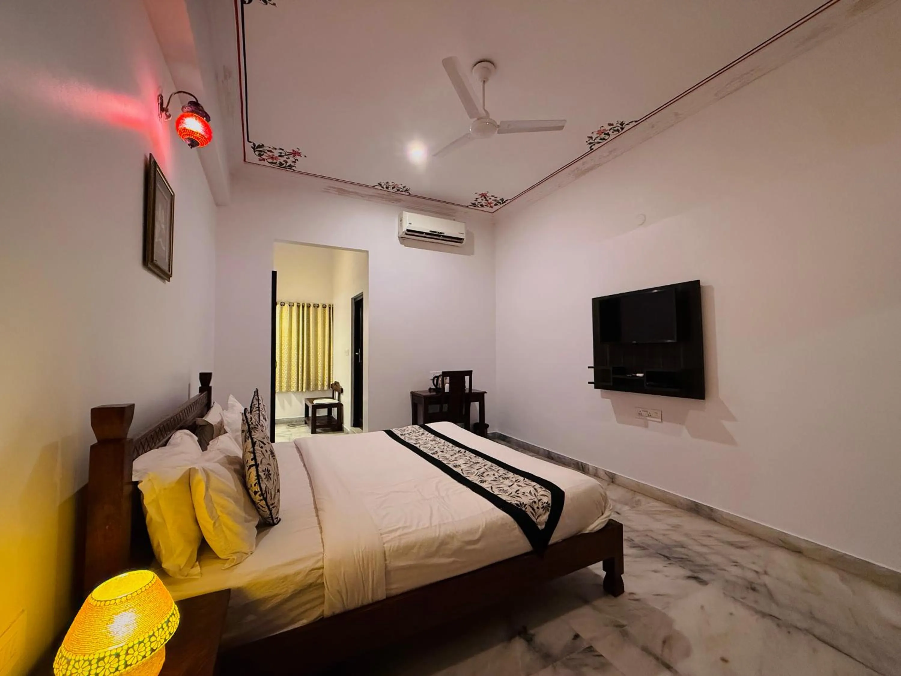 Communal lounge/ TV room, Bed in Atulya Niwas