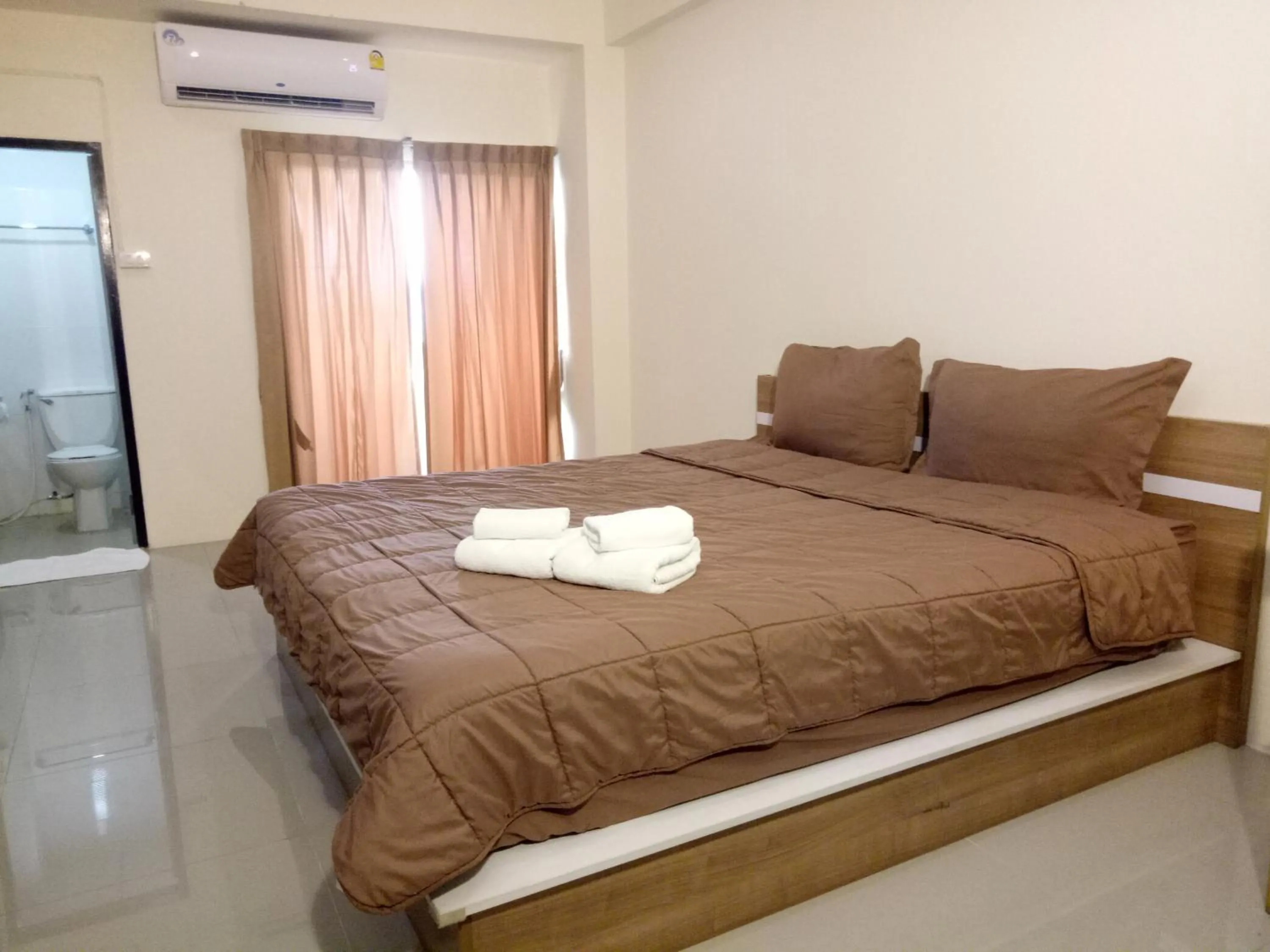 Bed in Komol Residence Bangkok