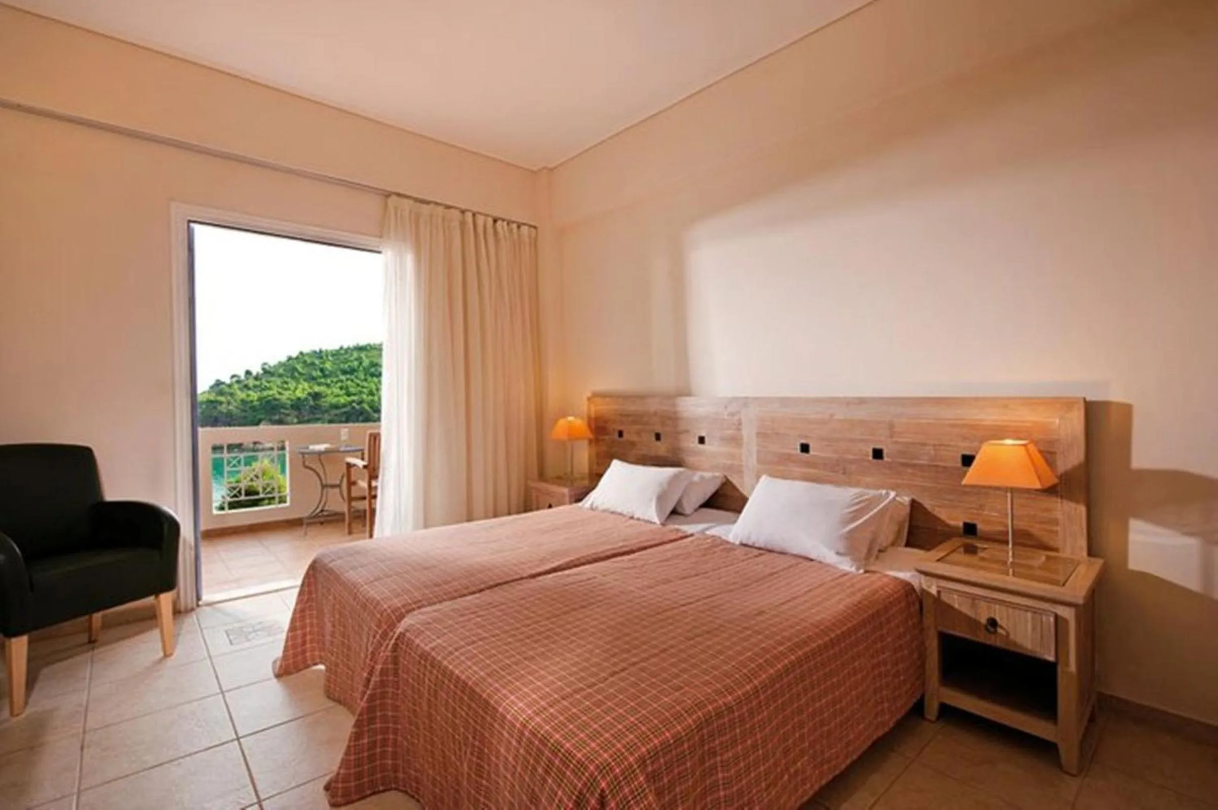 Bed in Alonissos Beach Bungalows And Suites Hotel