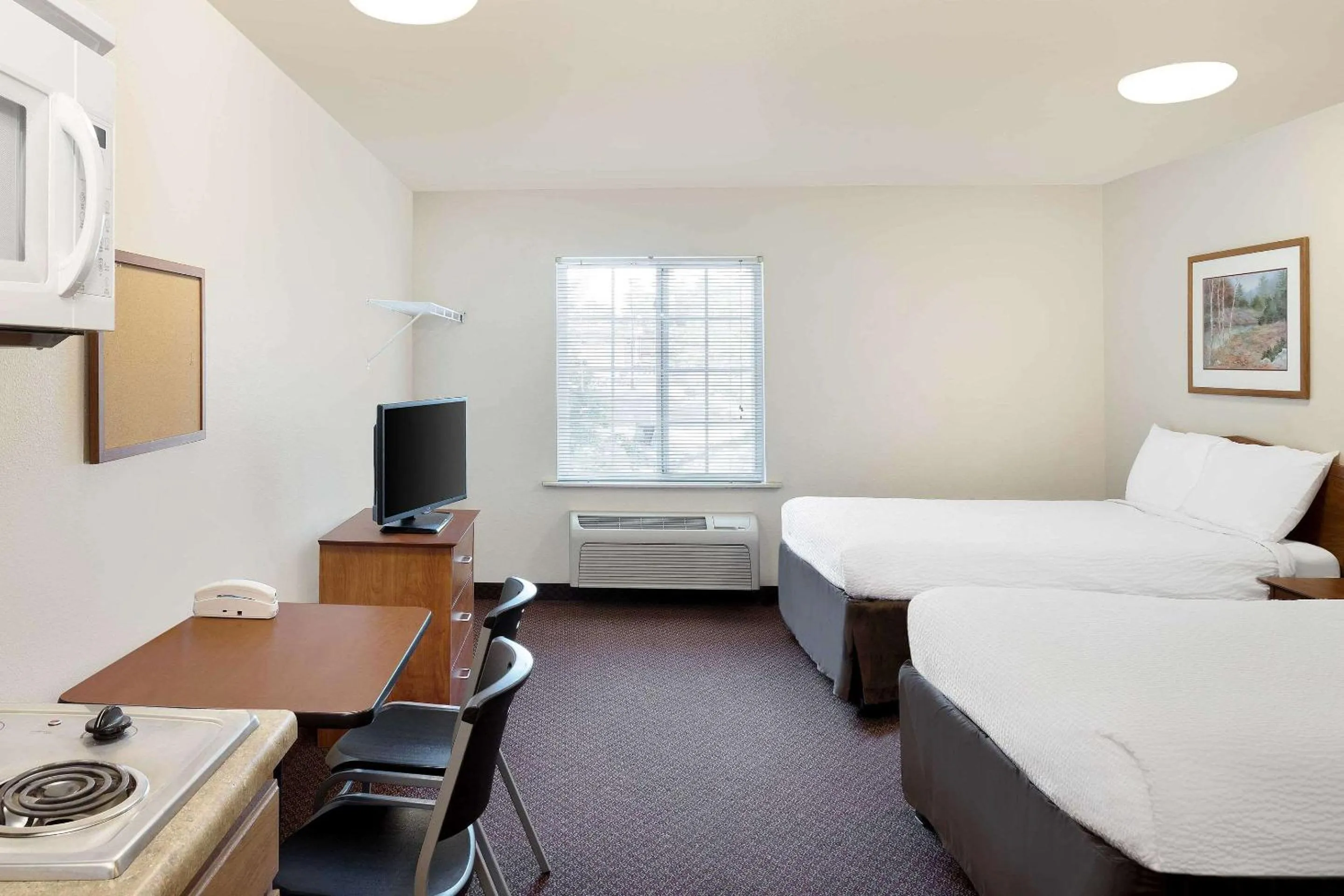 Photo of the whole room, Bed in WoodSpring Suites Tyler Rose Garden