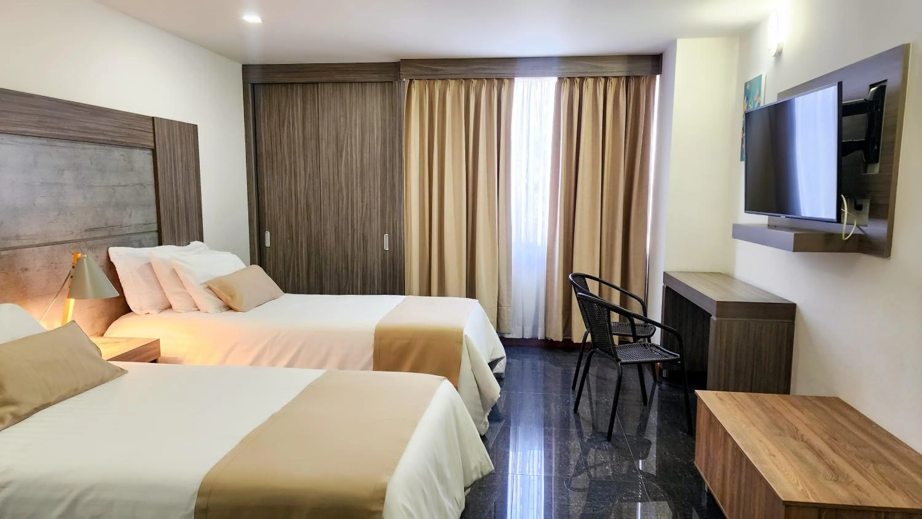 Bed in BE Suites Hotel Cali