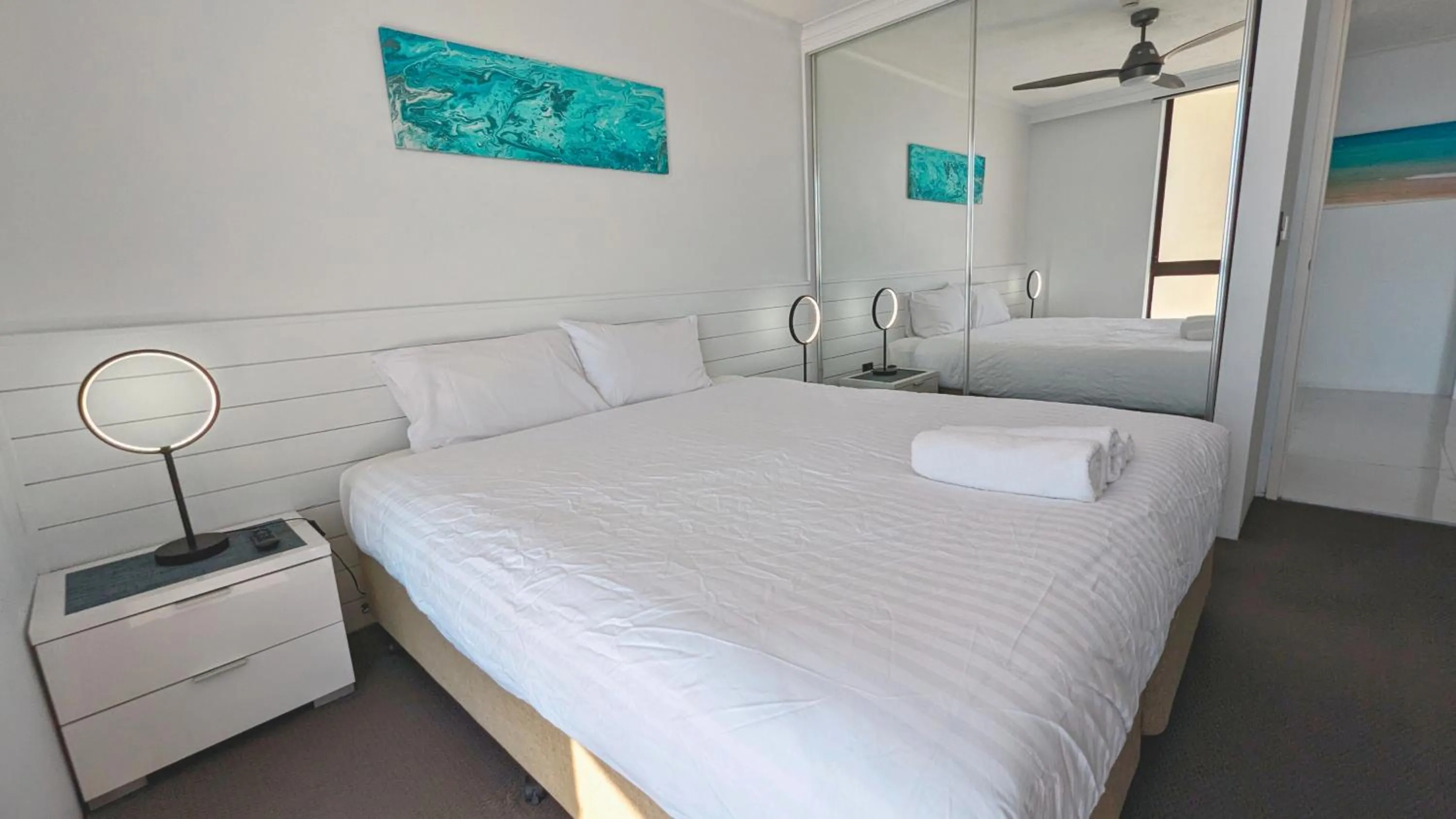 Bed in Olympus Beachfront Apartments