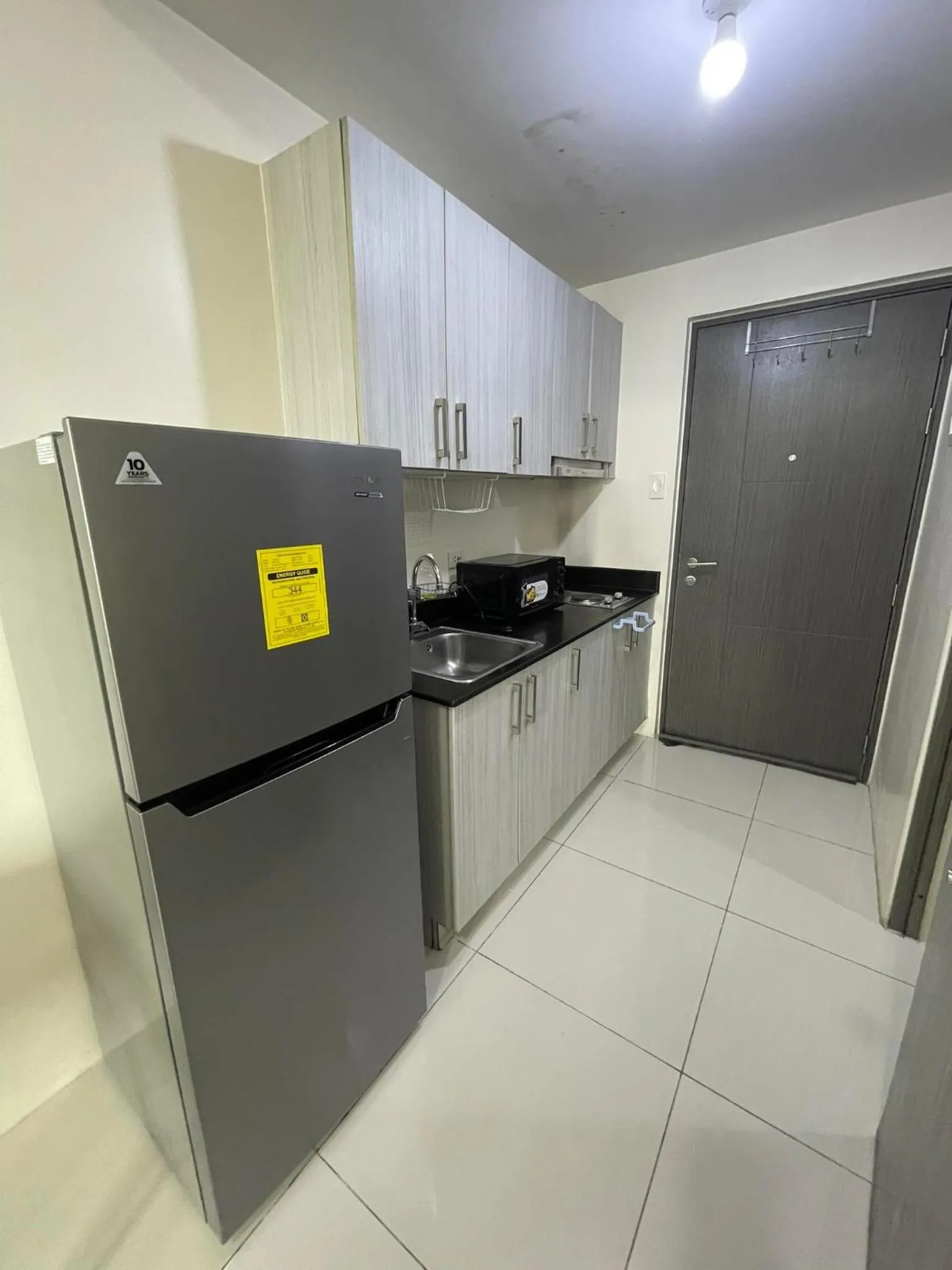 kitchen in Green Residences Stays by PBYY