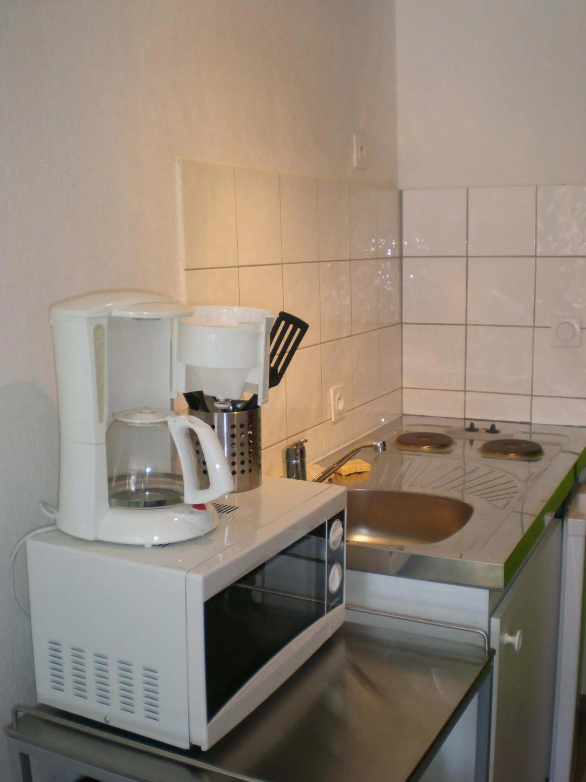 Kitchen or kitchenette in Appart Hotel de la Paix