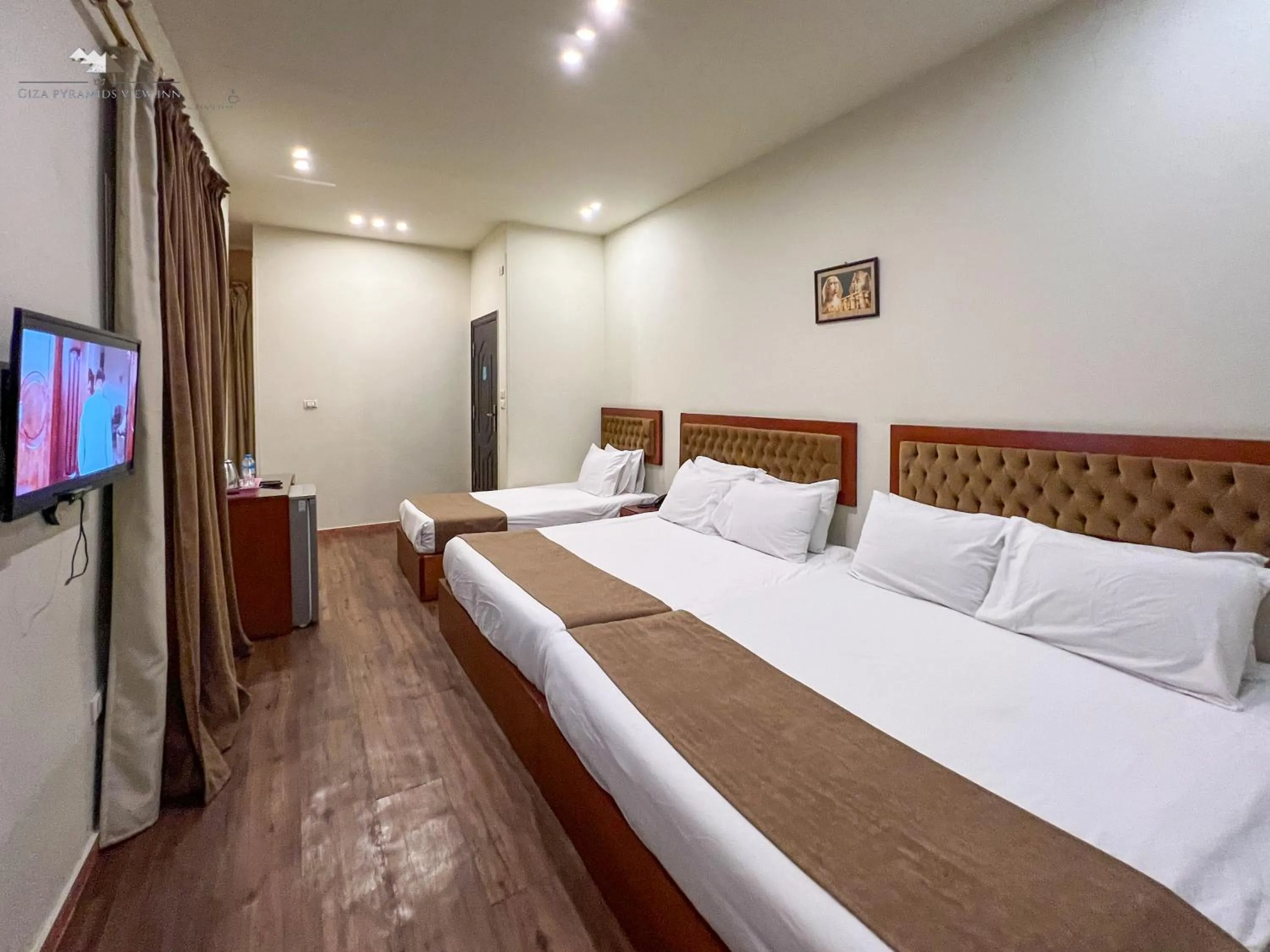 Communal lounge/ TV room, Bed in Giza Pyramids View Inn