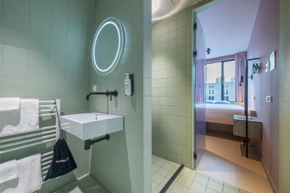 Bathroom, Bed in hotel emma next