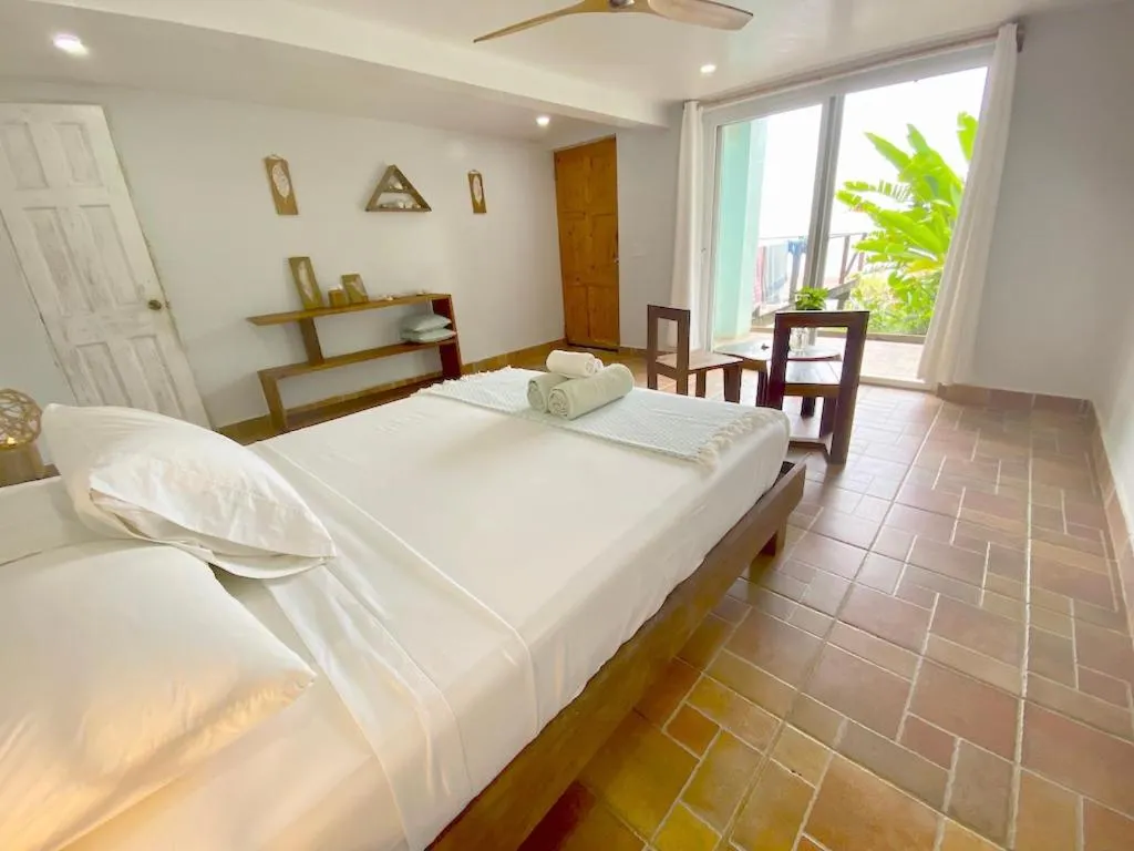 Photo of the whole room, Bed in Bird Island Bungalows