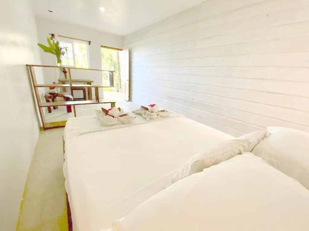 Bed in Bird Island Bungalows