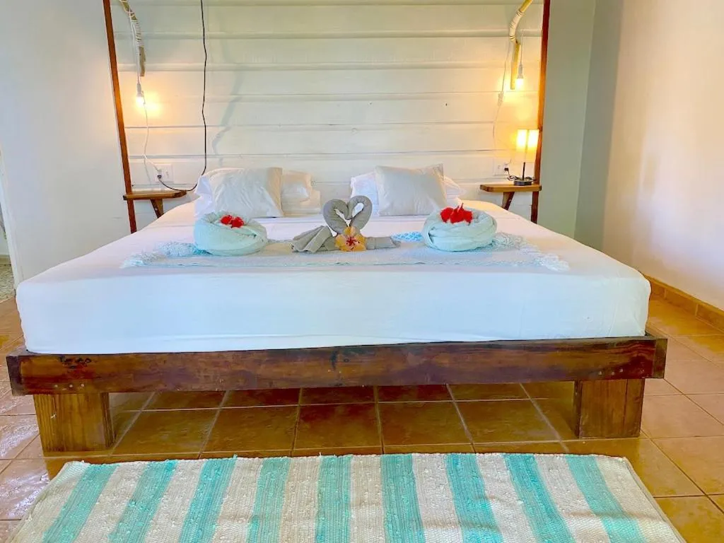 Bed in Bird Island Bungalows