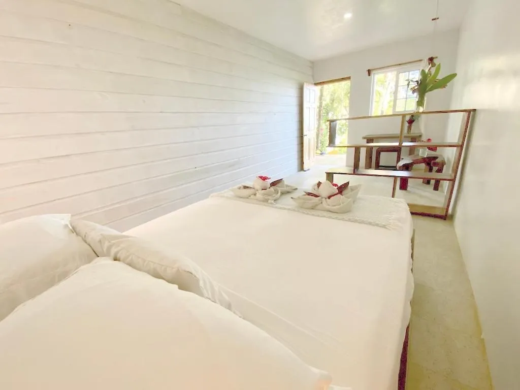 Bed in Bird Island Bungalows