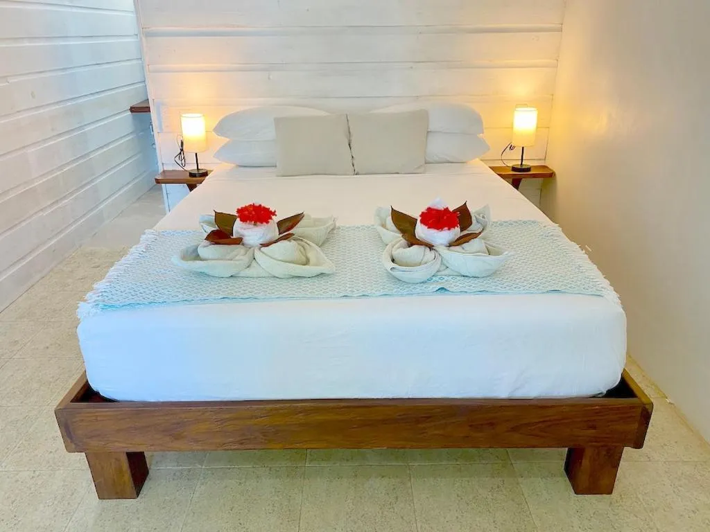 Bed in Bird Island Bungalows