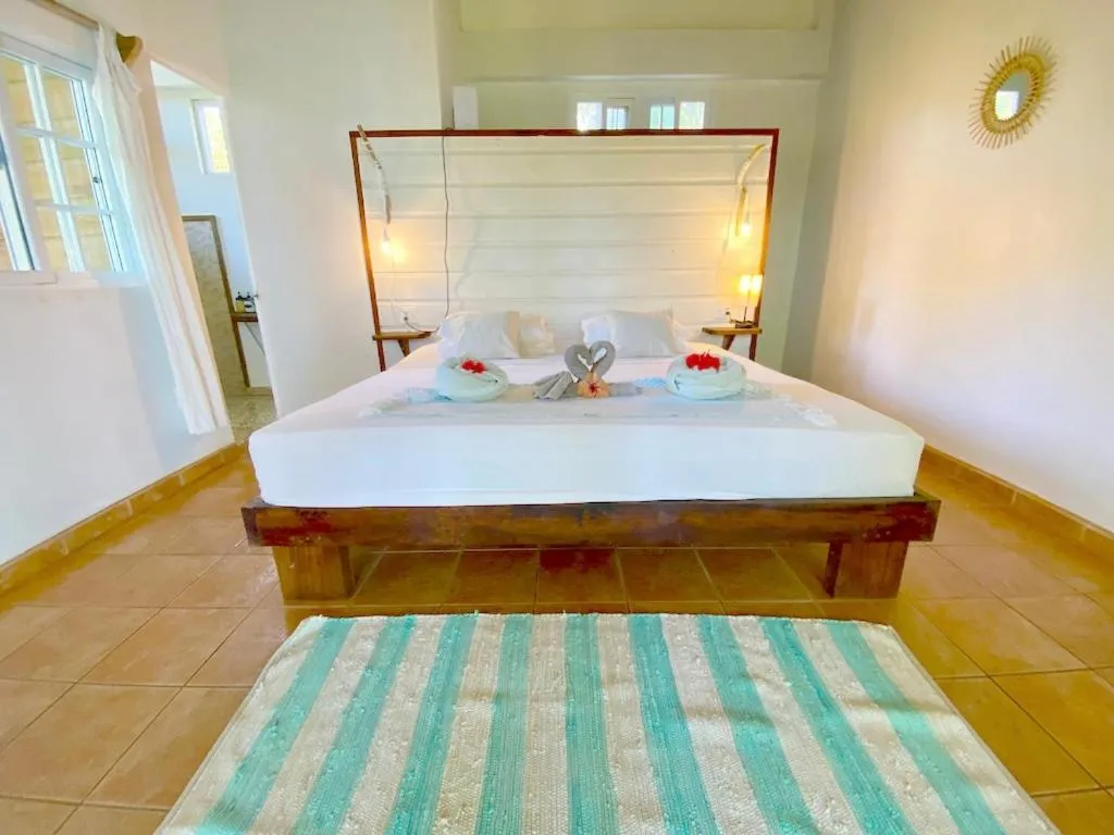 Bed in Bird Island Bungalows
