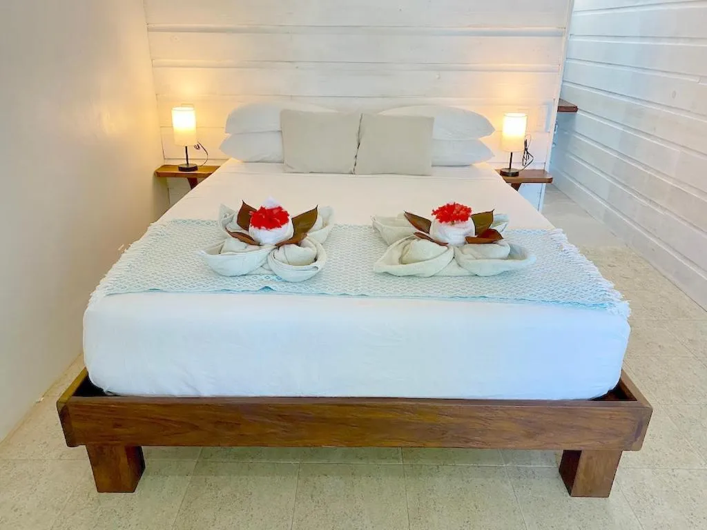 Bed in Bird Island Bungalows