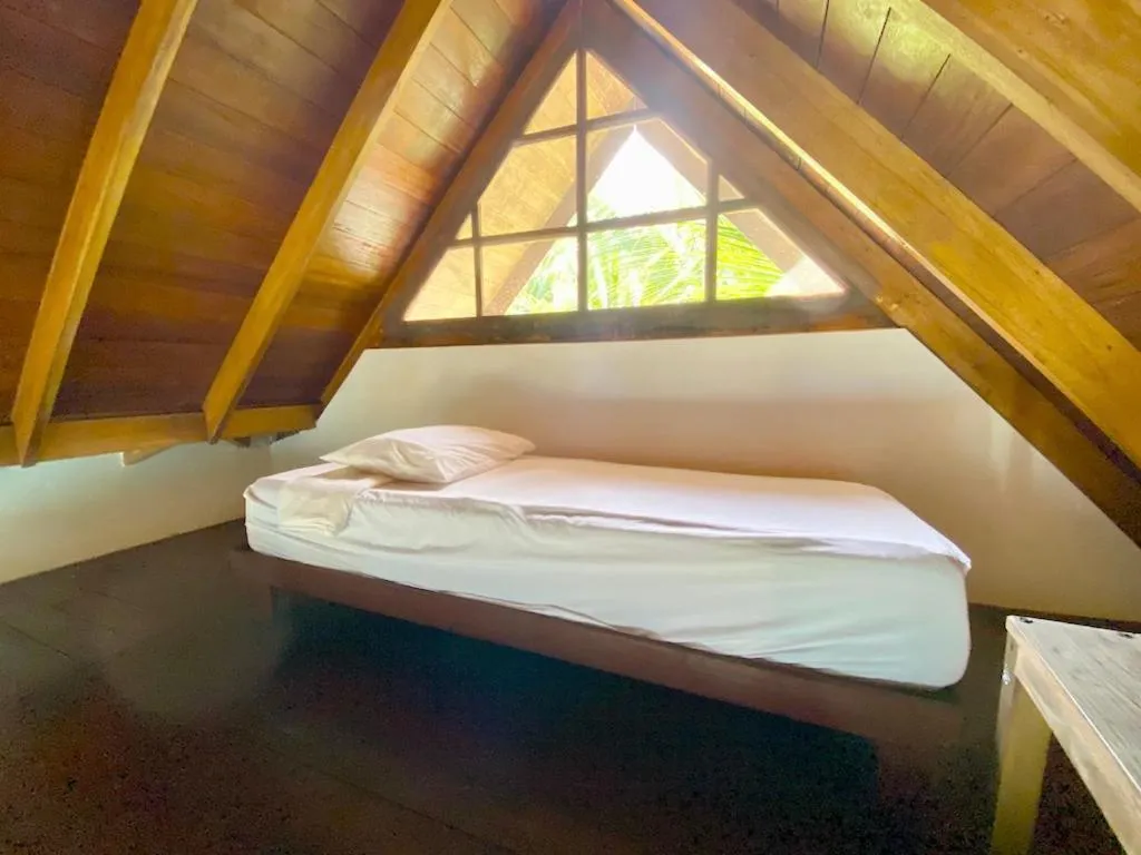 Bed in Bird Island Bungalows