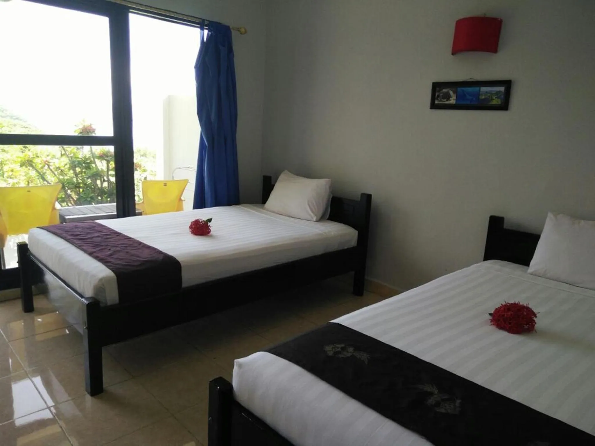 Bed in CF Komodo Hotel