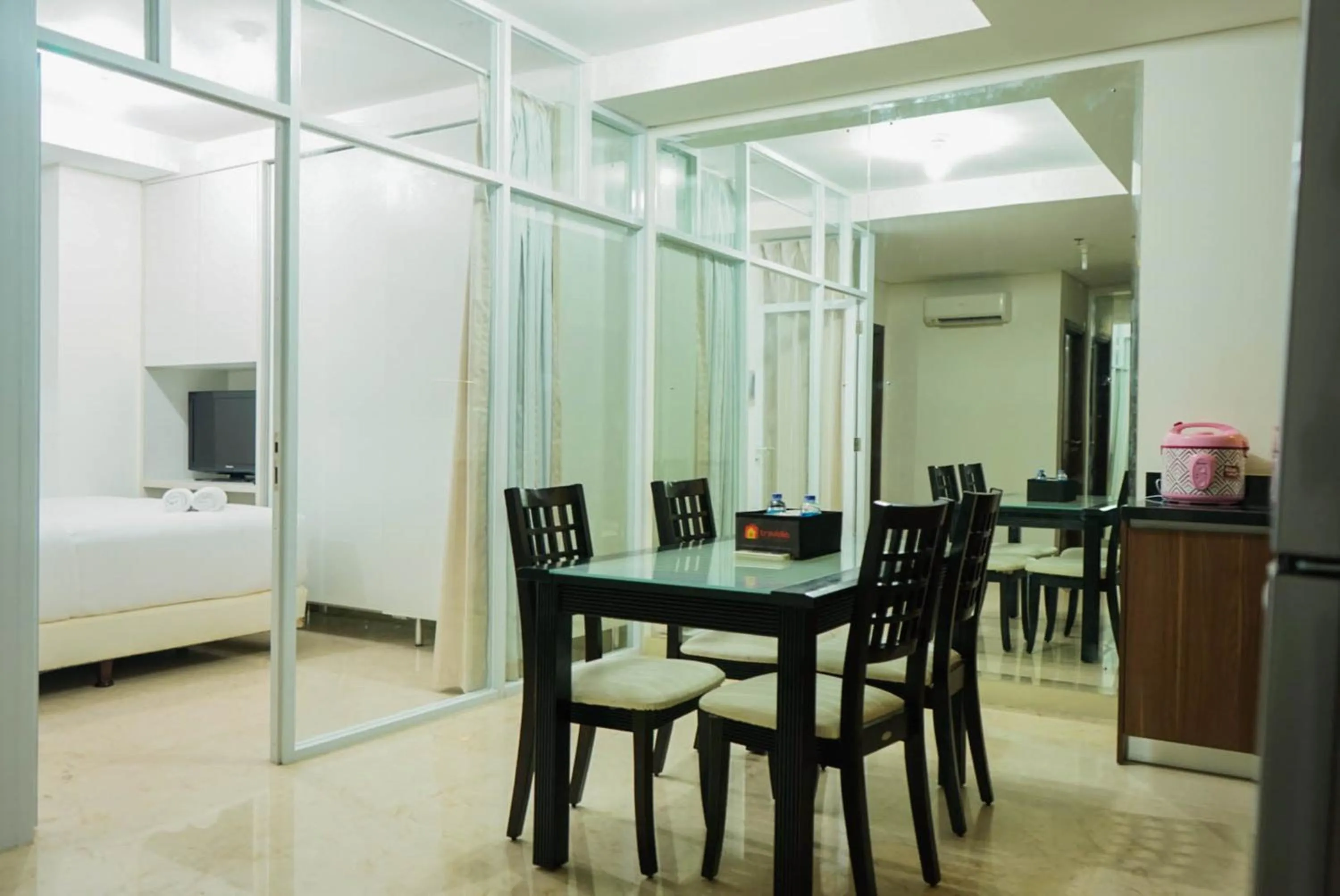 Dining area in 2BR with Study Room at L'Avenue Apartment By Travelio