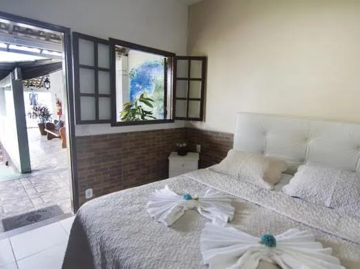 Bed in Pousada Três Pescadores