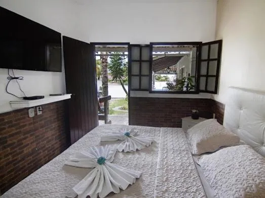 Bed in Pousada Três Pescadores