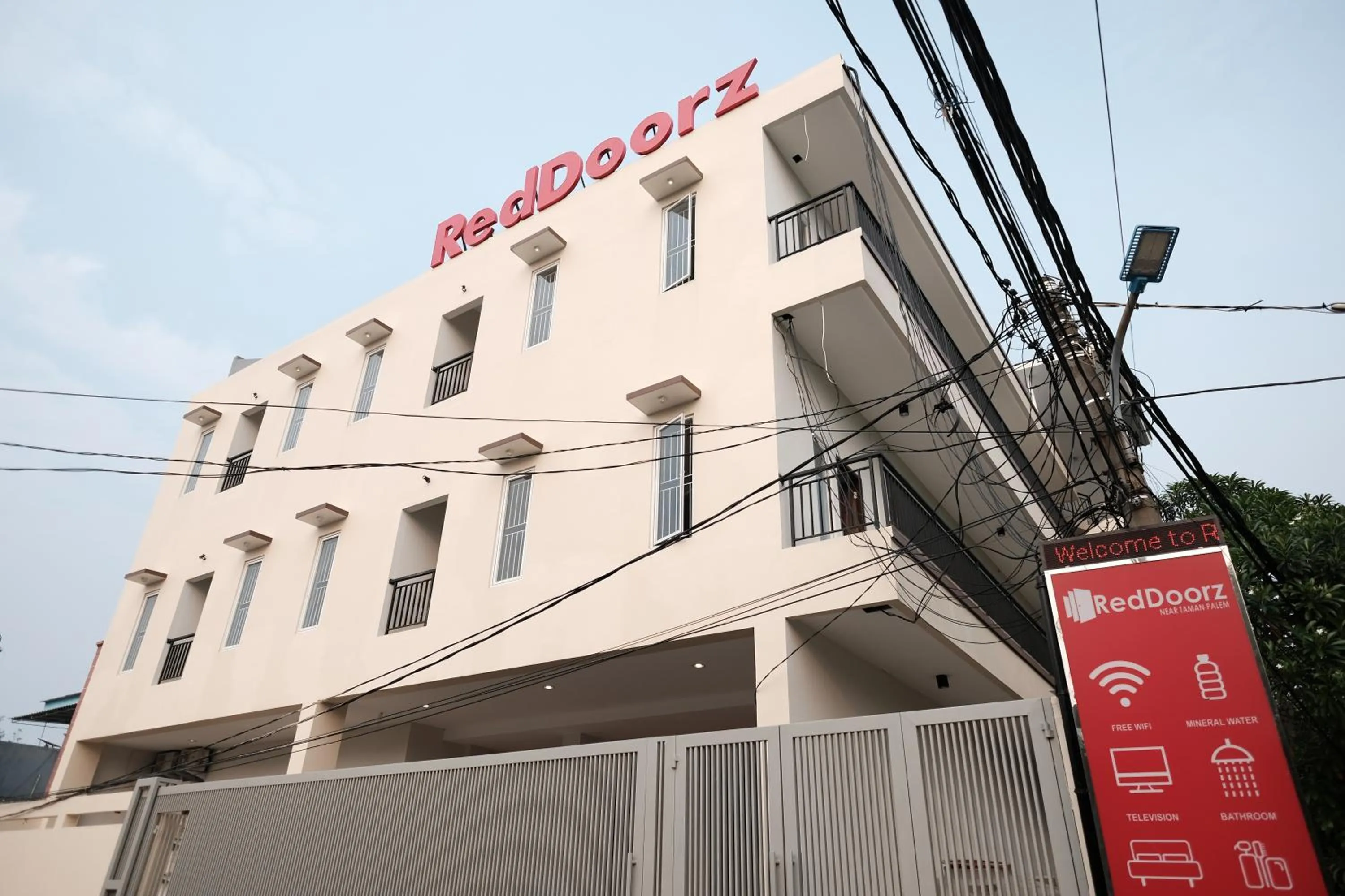 Property logo or sign in RedDoorz near Taman Palem