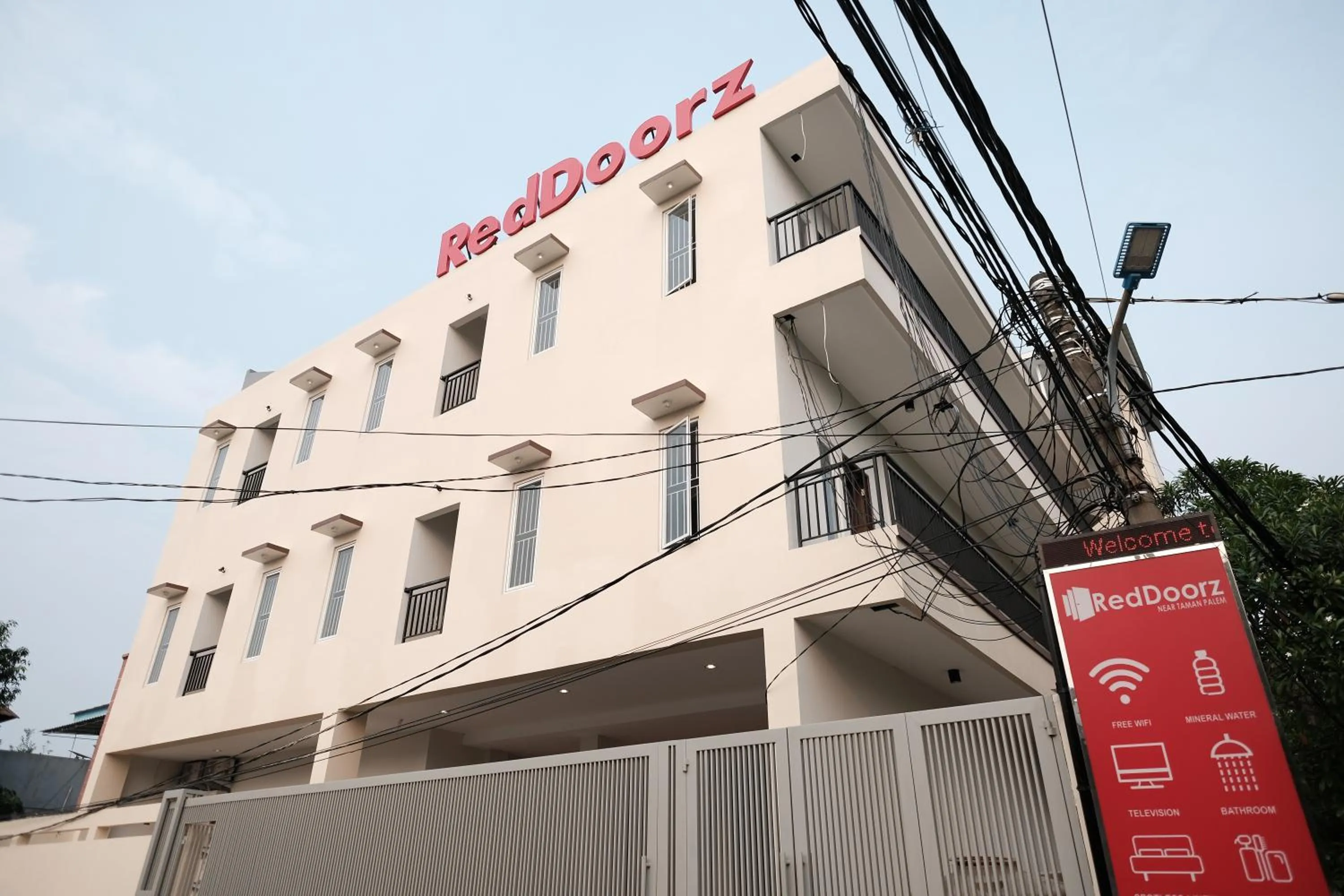 Property logo or sign in RedDoorz near Taman Palem