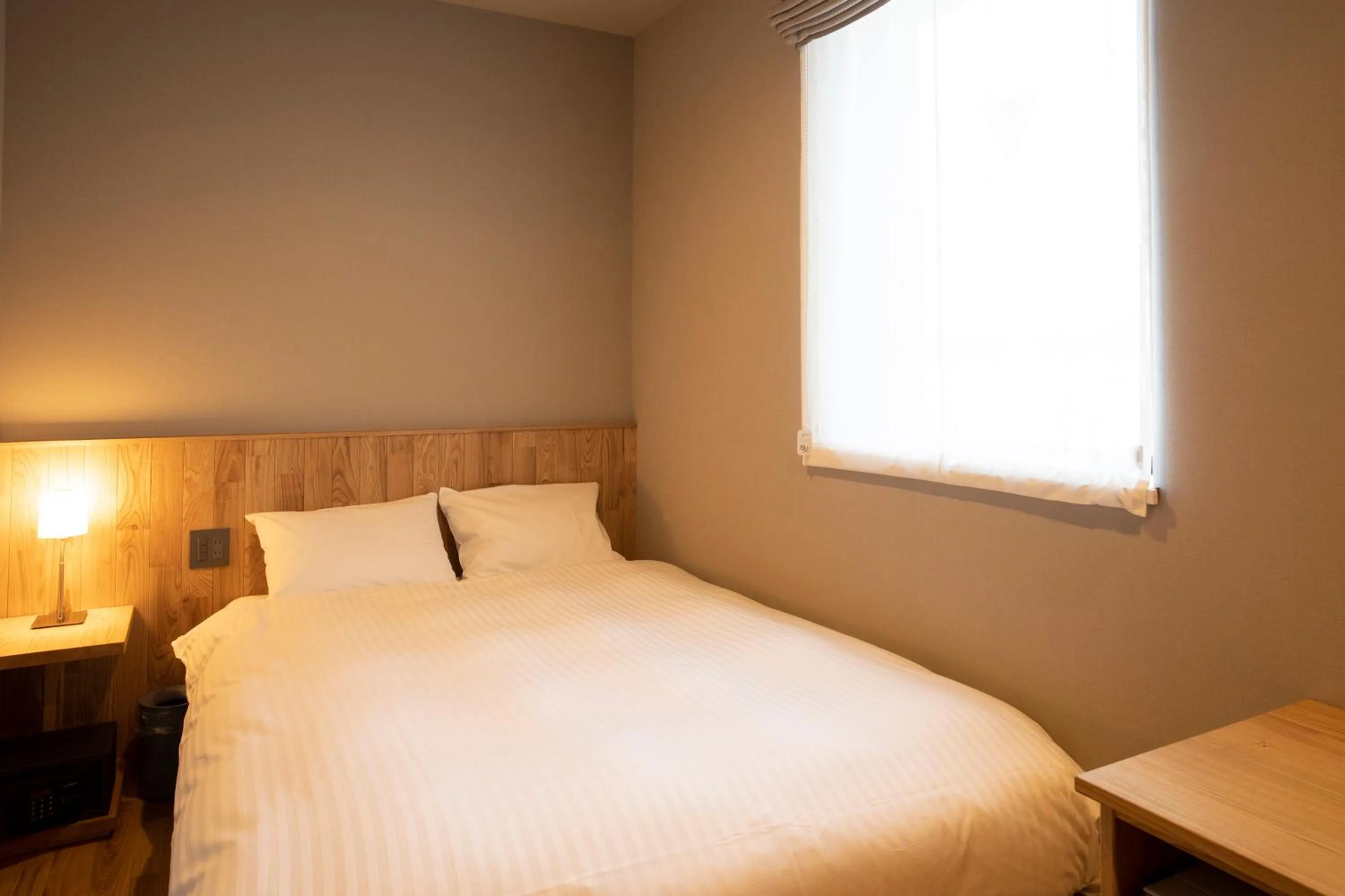 Bed in MASCOS HOTEL Masuda Onsen