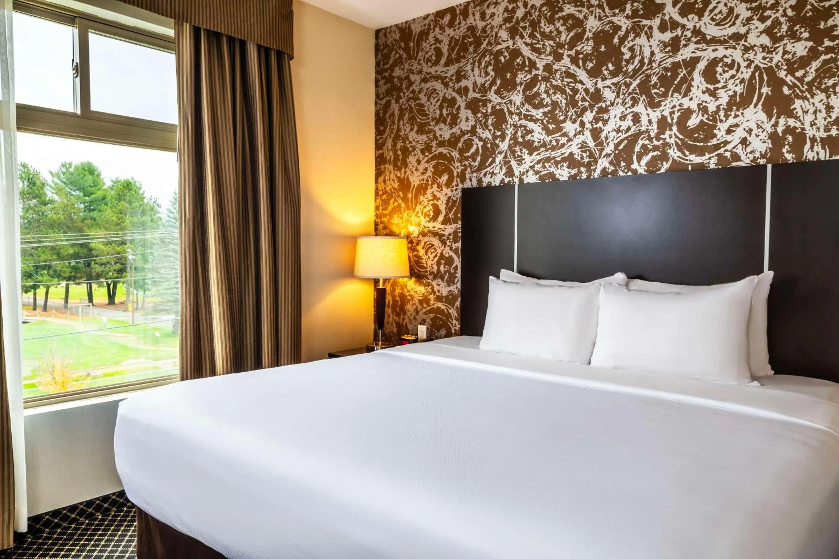 Bed in Quality Inn & Suites