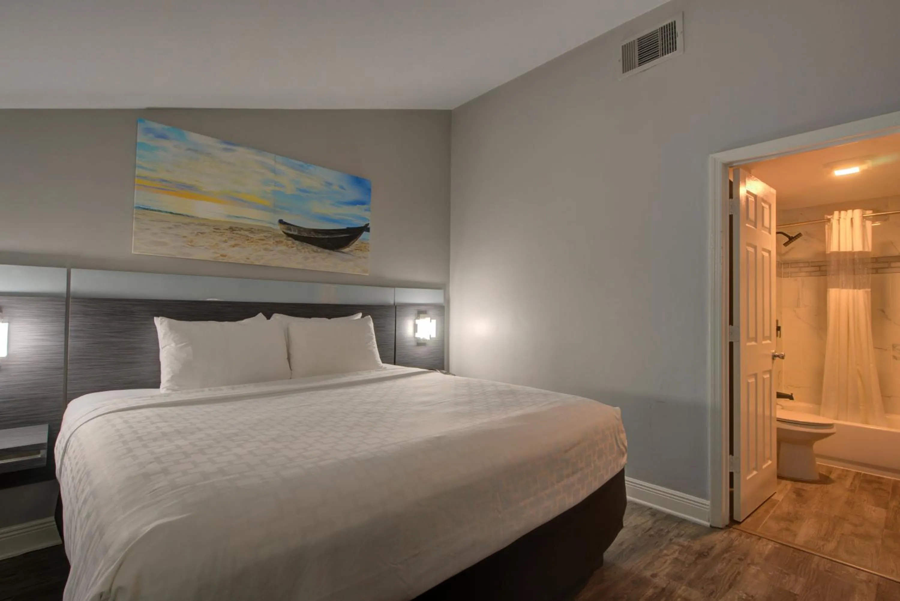 Toilet, Bed in Clarion Pointe Tampa-Brandon Near Fairgrounds and Casino