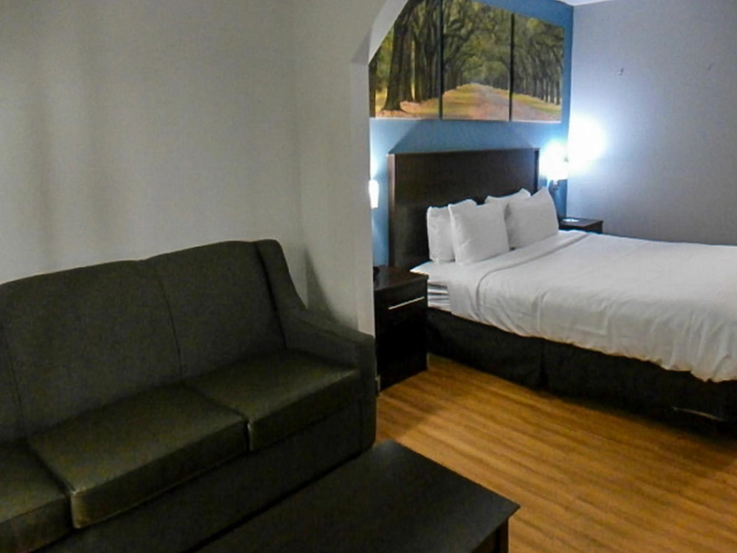 Seating area, Bed in Clarion Pointe Hinesville near Fort Stewart