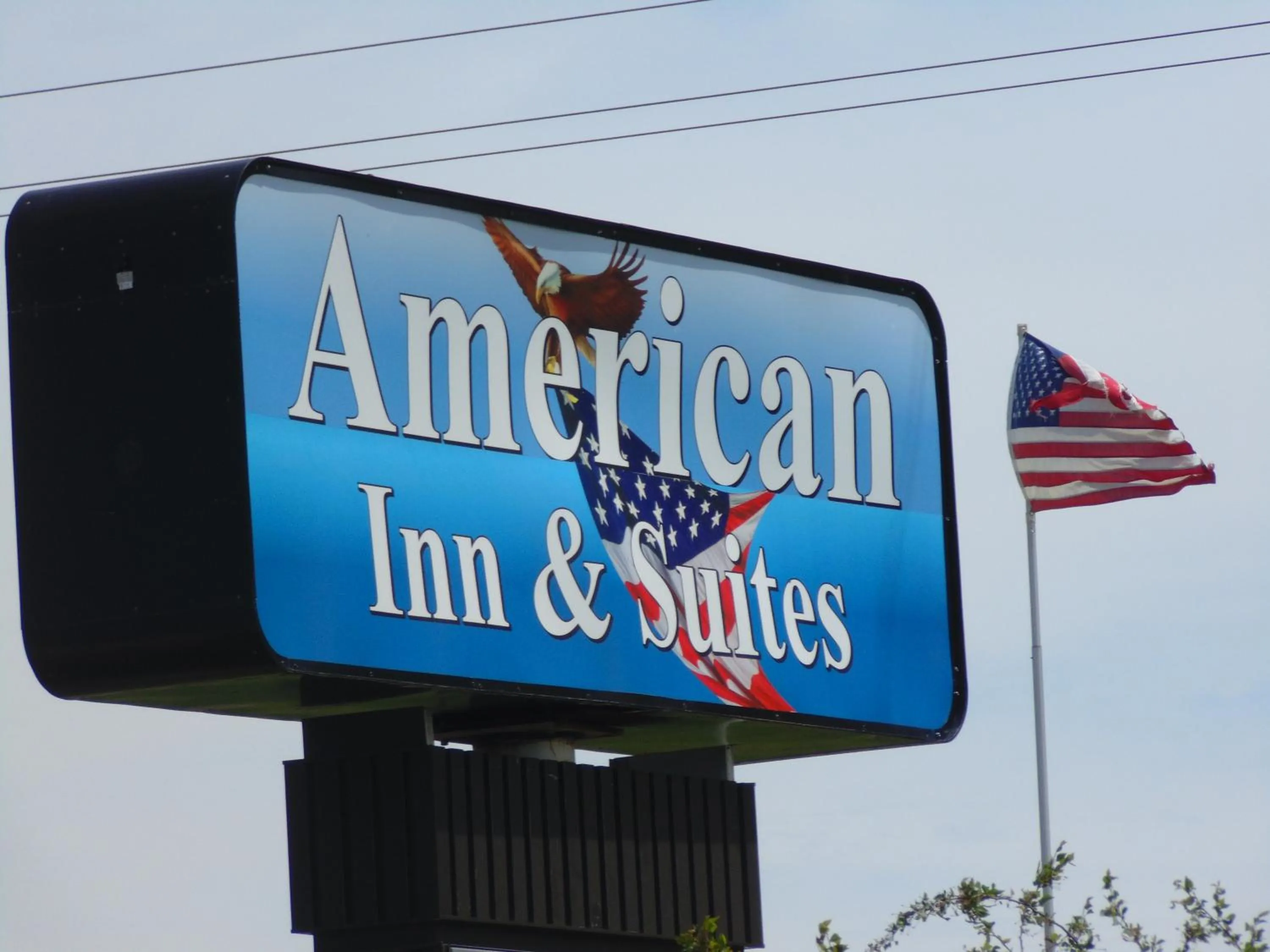 Property logo or sign in American Inn and Suites Houghton Lake