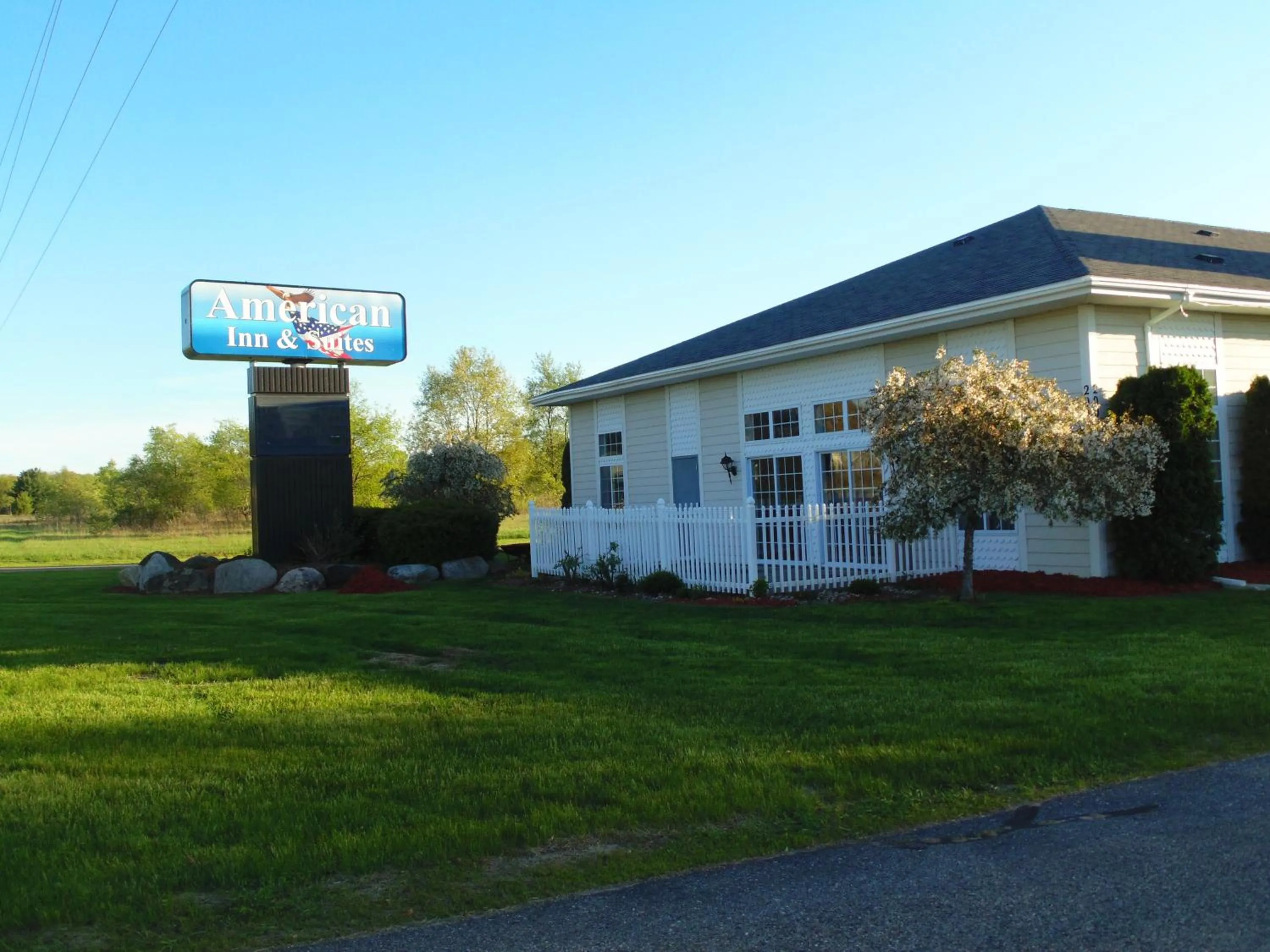 Property logo or sign in American Inn and Suites Houghton Lake