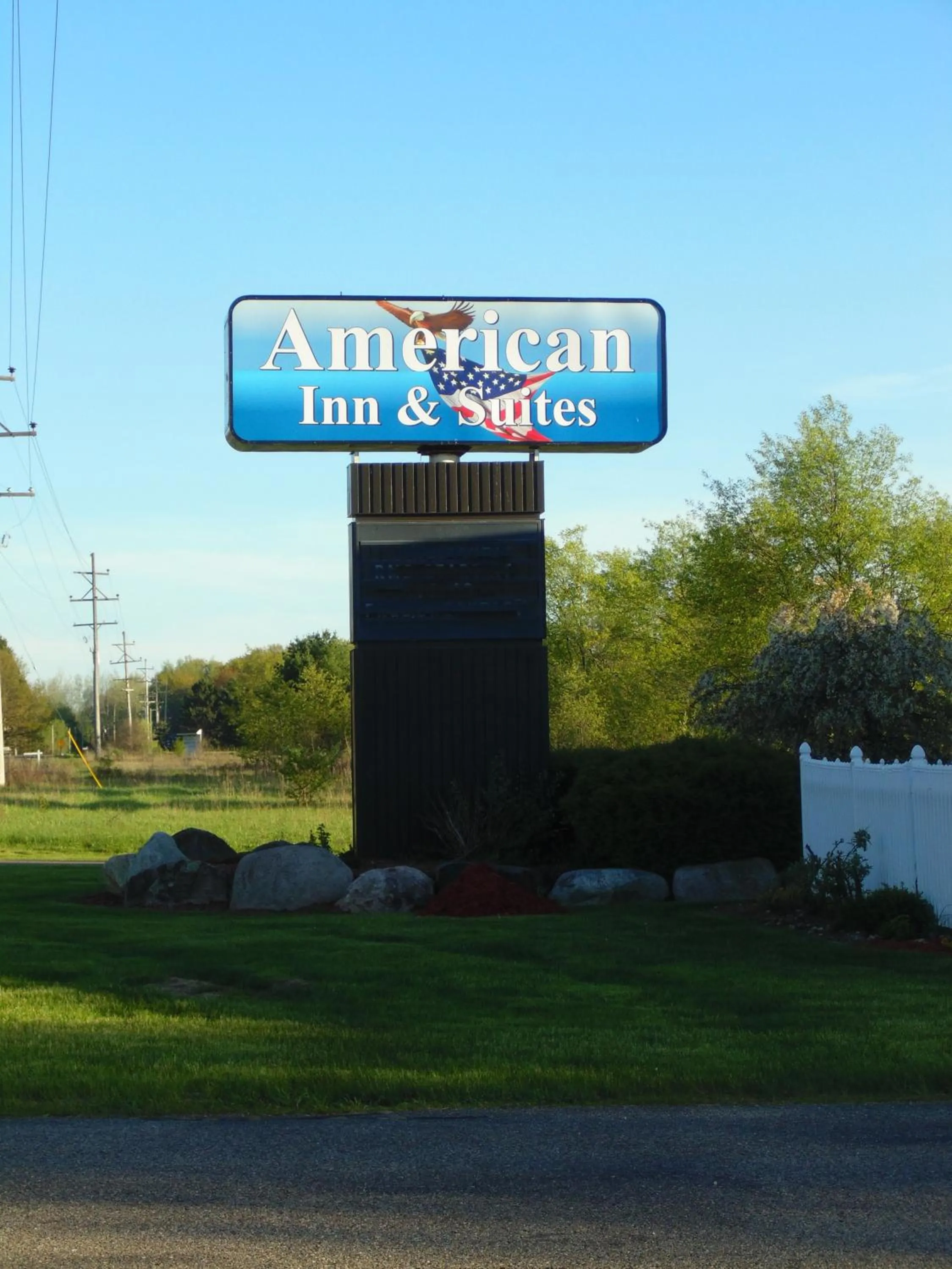 Property logo or sign in American Inn and Suites Houghton Lake