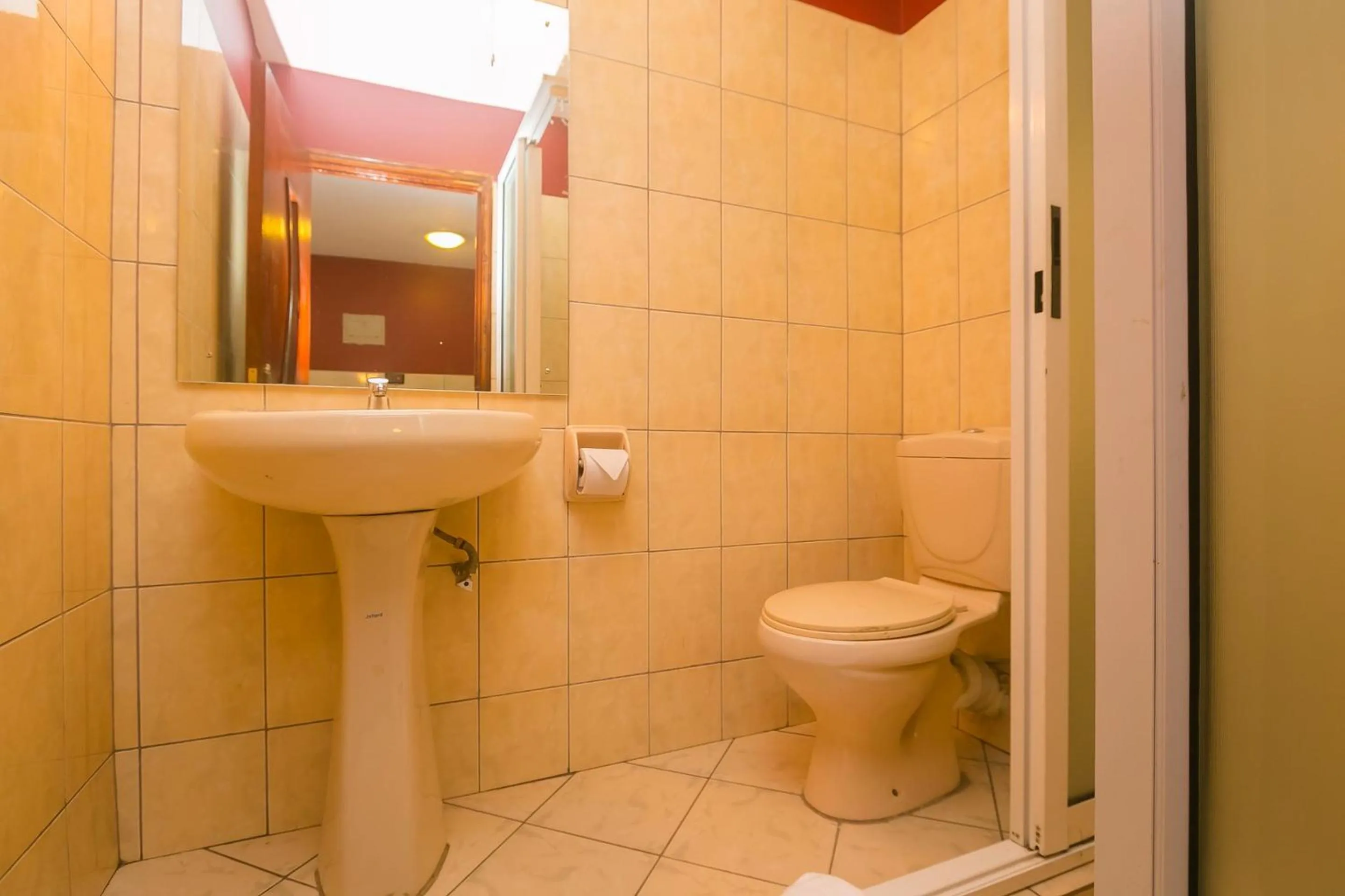 Toilet in Plus254 Hotel