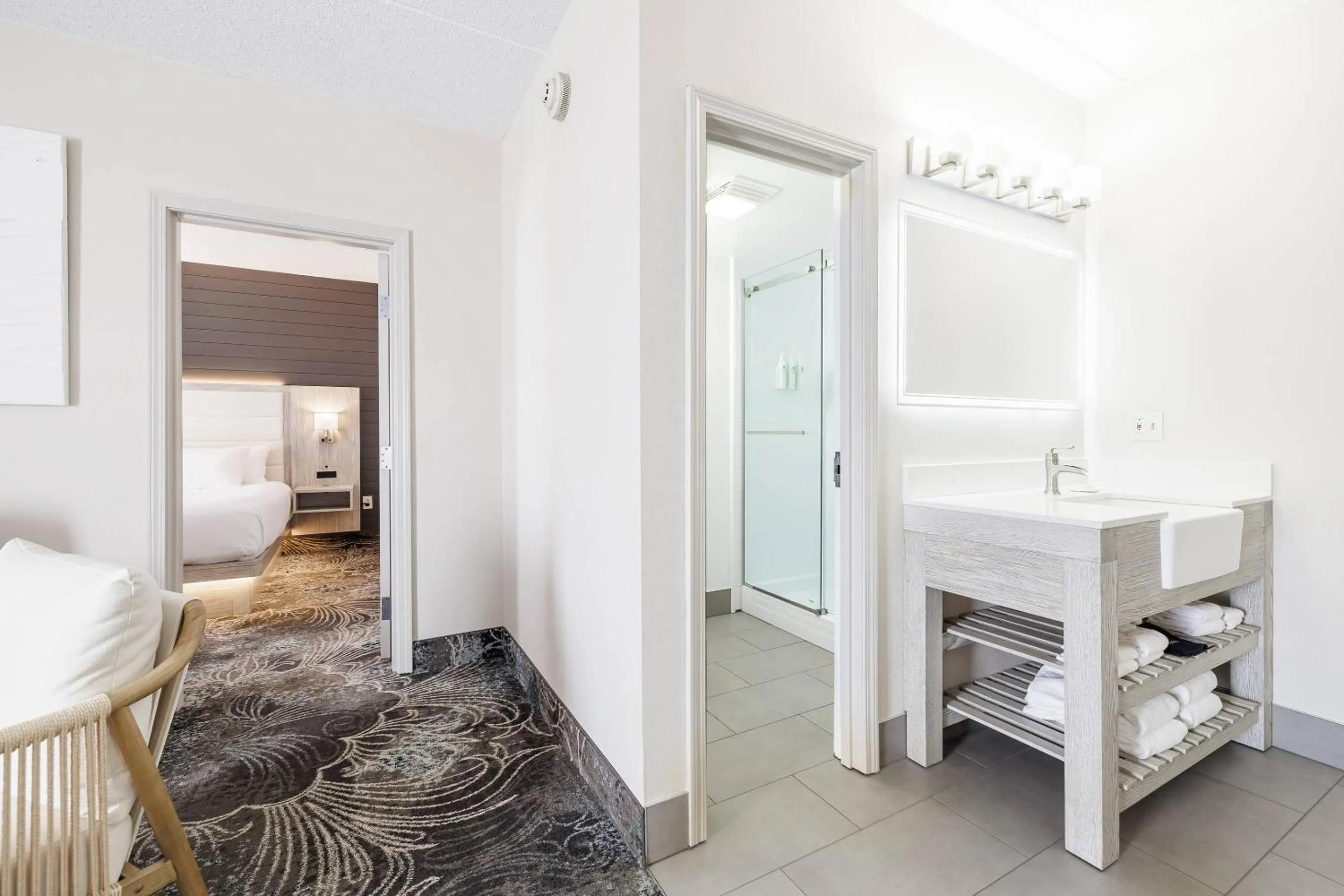 Bedroom in Oakfield Hotel & Suites Rochester, an Ascend Collection Hotel