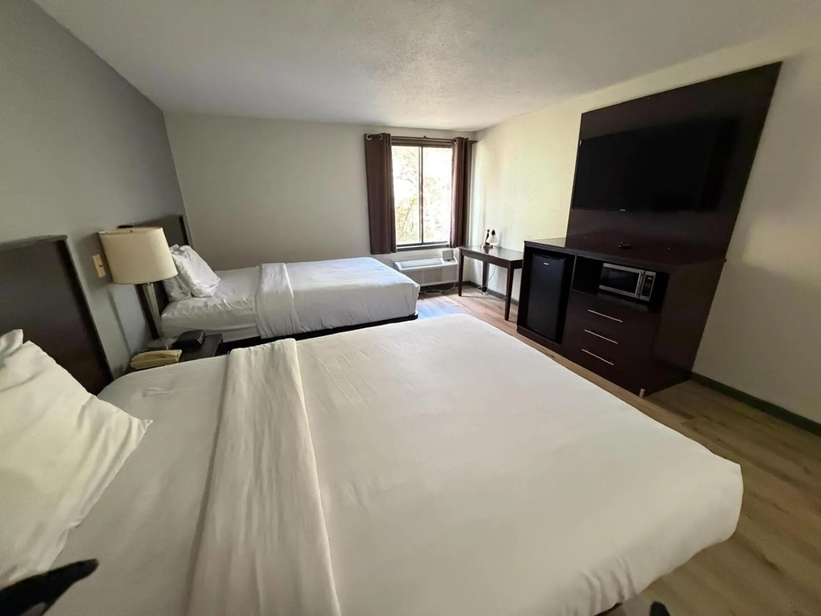 Bed in University Inn & Suites