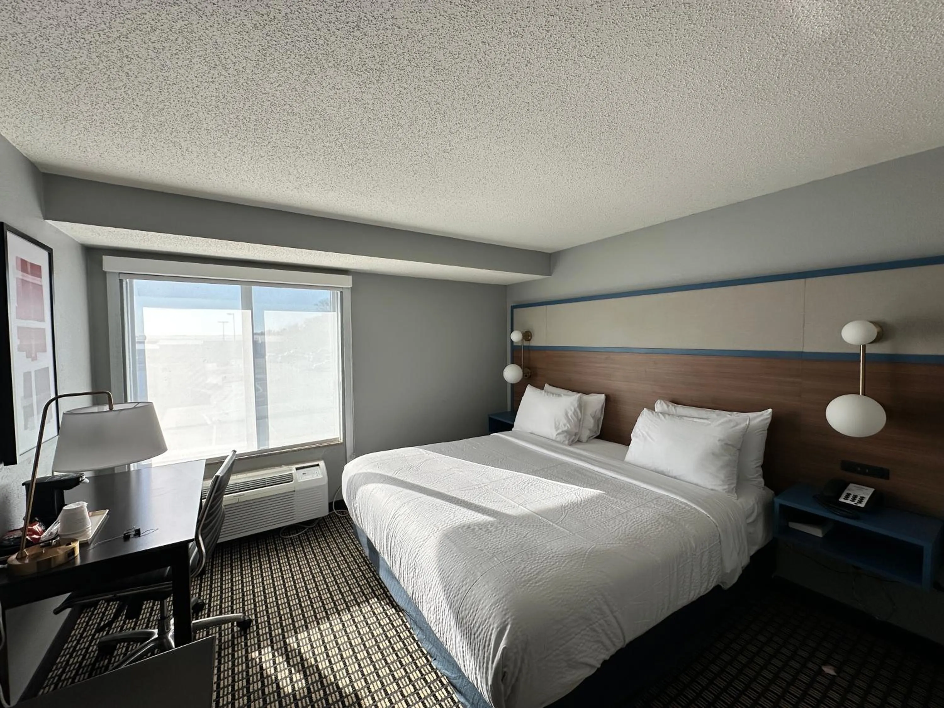 Bed in AmericInn by Wyndham Reedsburg