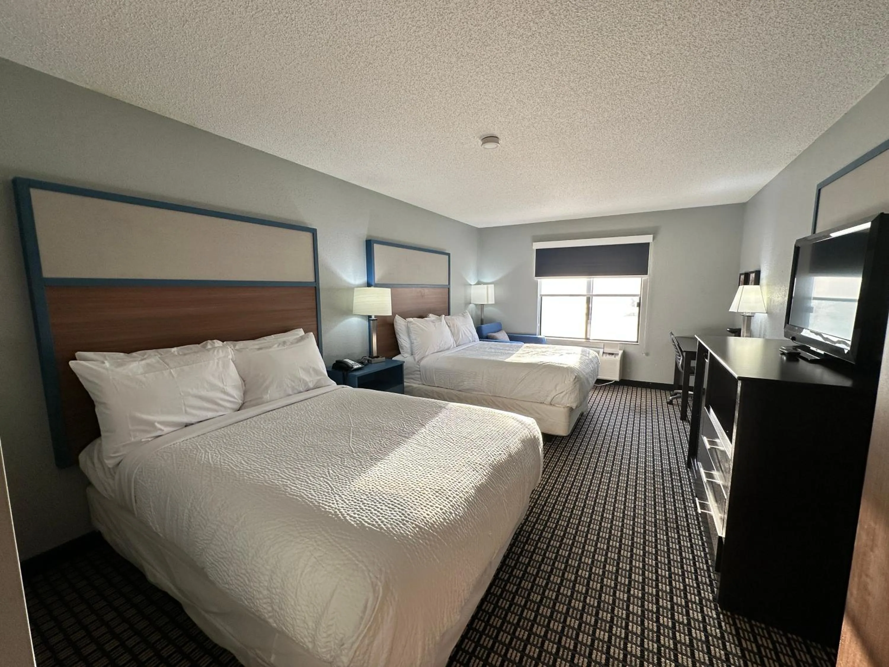 Bed in AmericInn by Wyndham Reedsburg