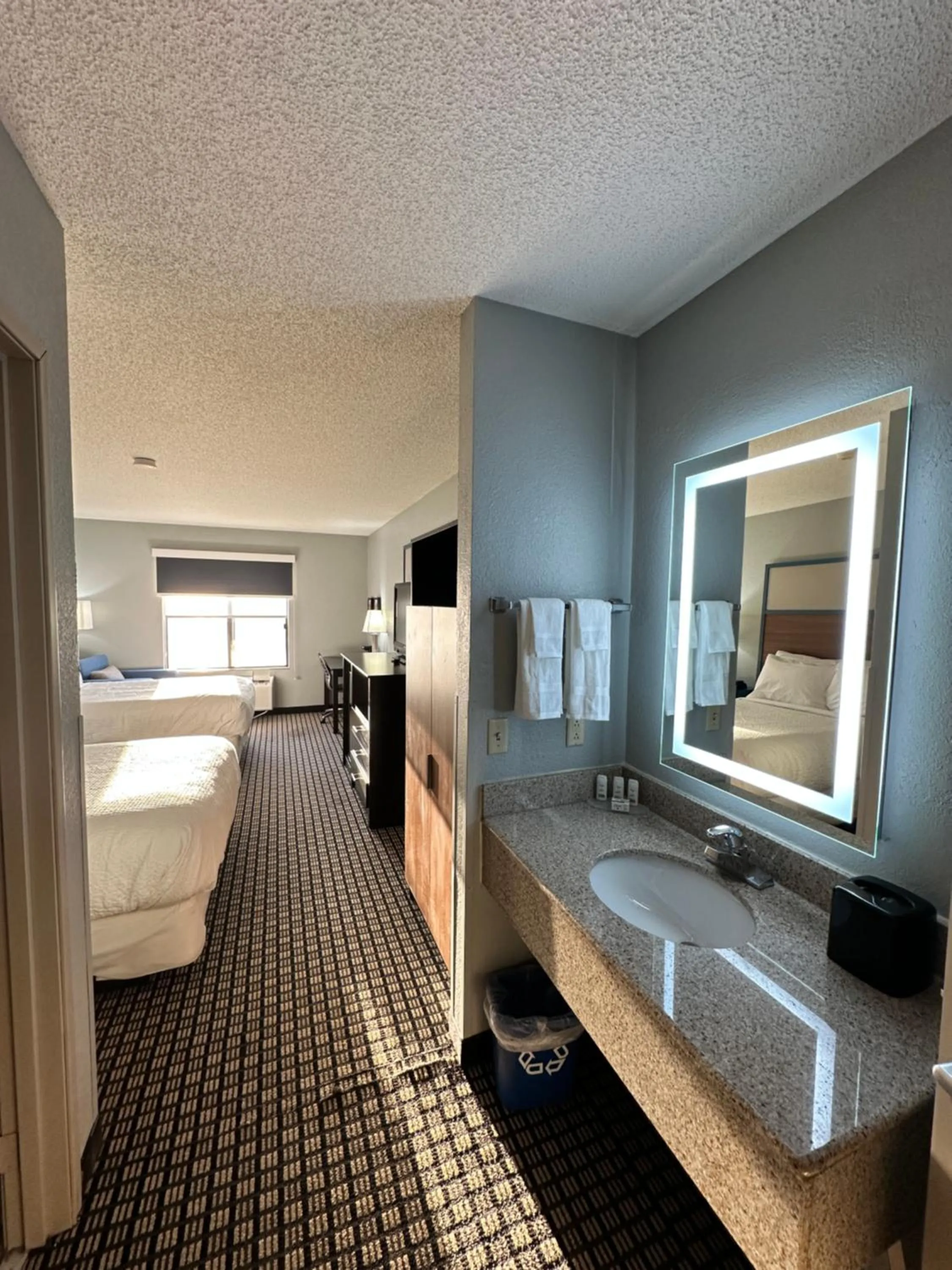 Bed in AmericInn by Wyndham Reedsburg