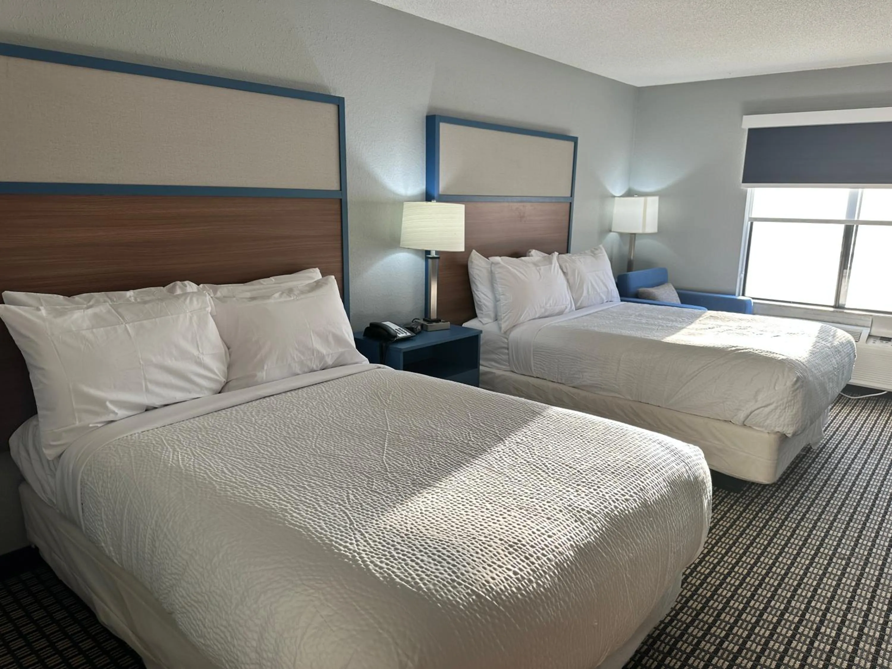 Bed in AmericInn by Wyndham Reedsburg