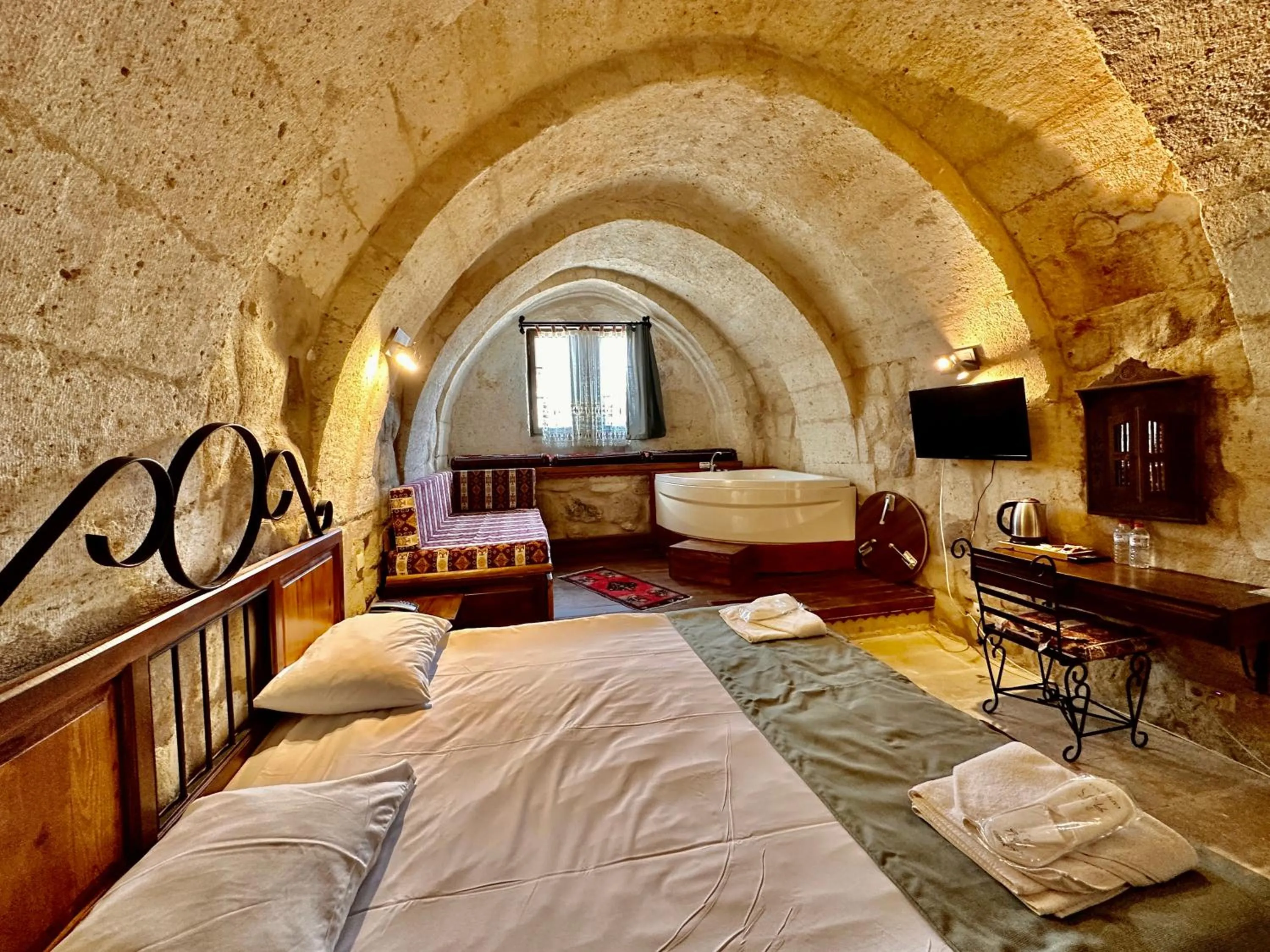 Bed in Harkasos Cave Hotel