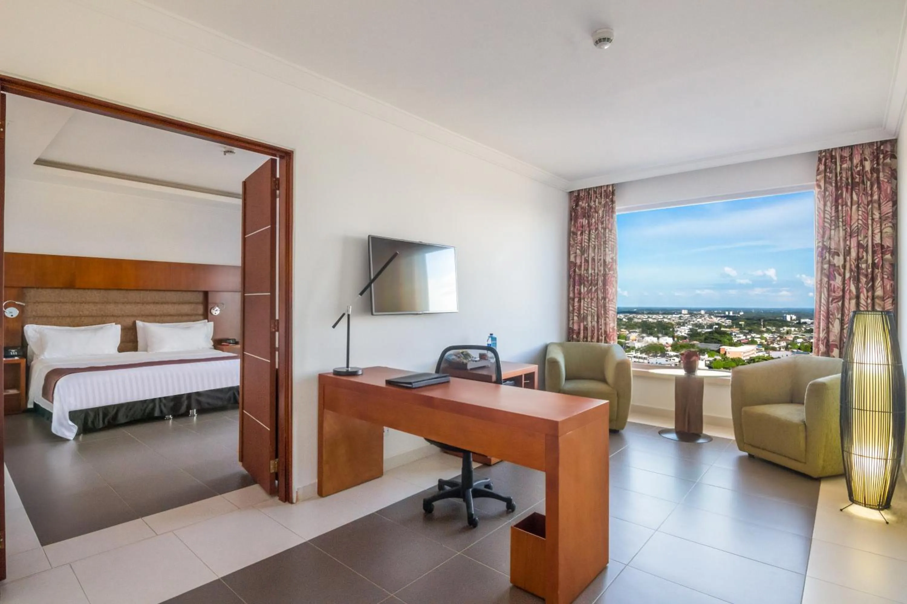 Communal lounge/ TV room, Bed in GHL Hotel Grand Villavicencio