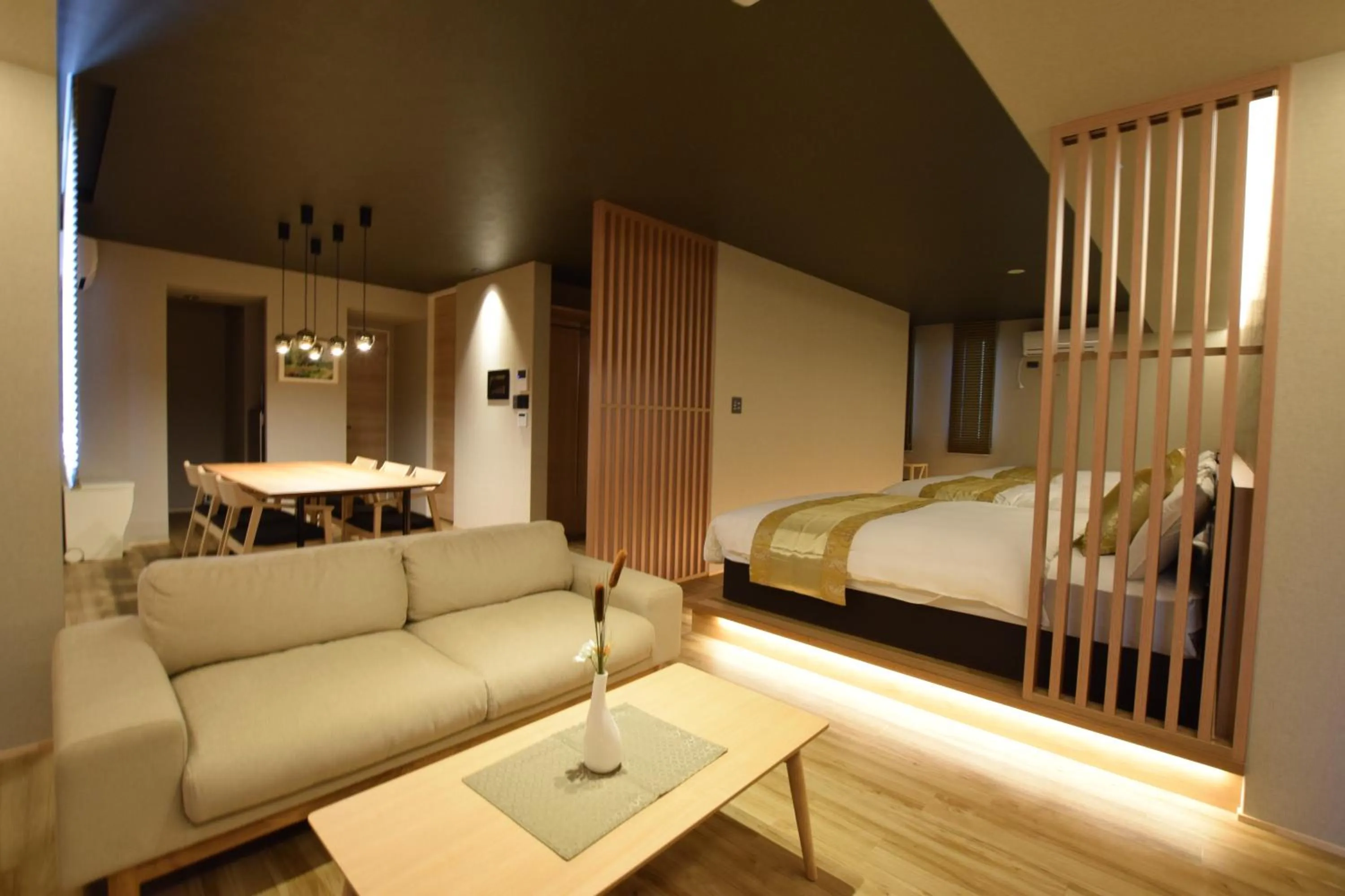 Photo of the whole room, Bed in GRAND BASE Beppu Ekimae