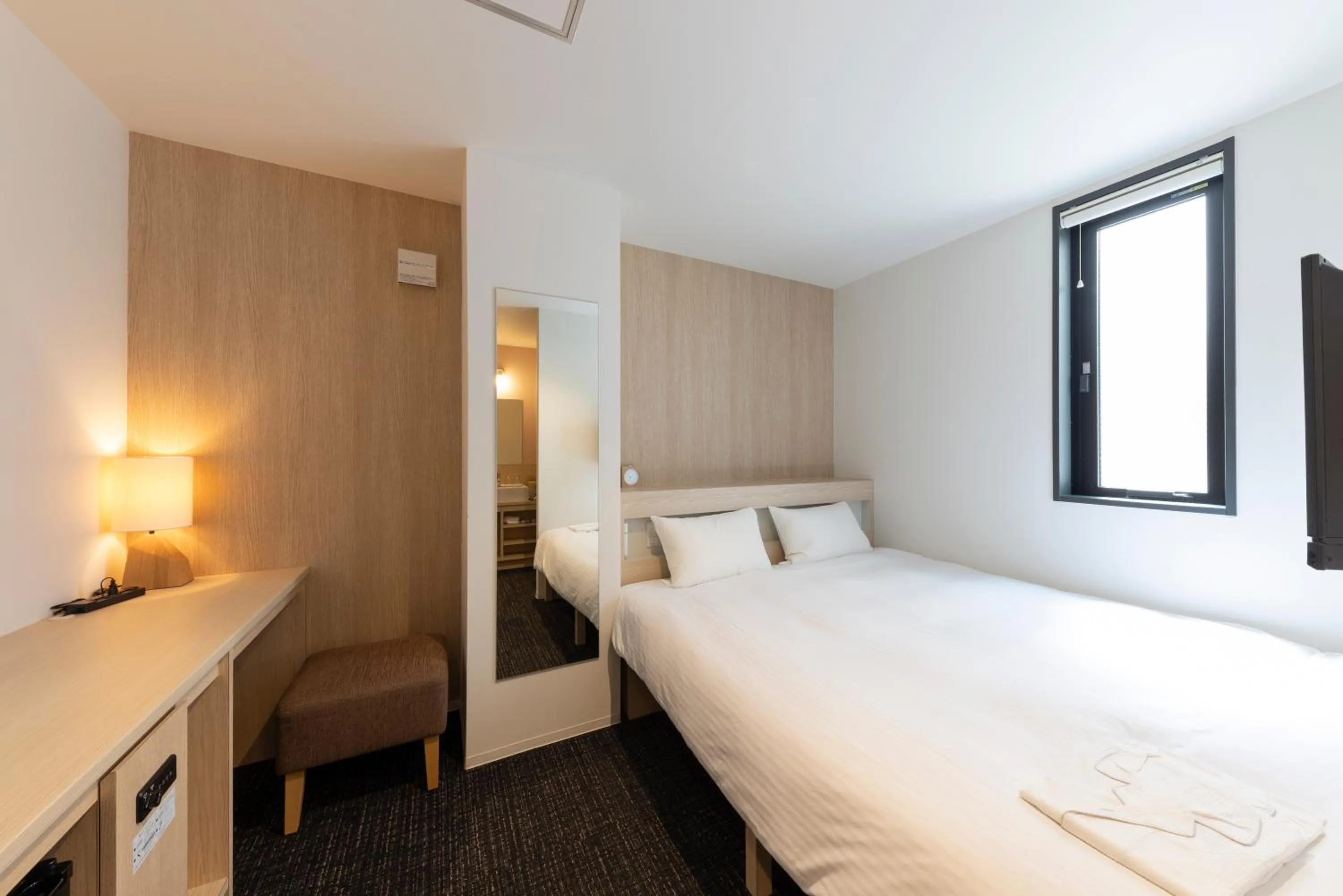 Photo of the whole room, Bed in WeBase Hiroshima