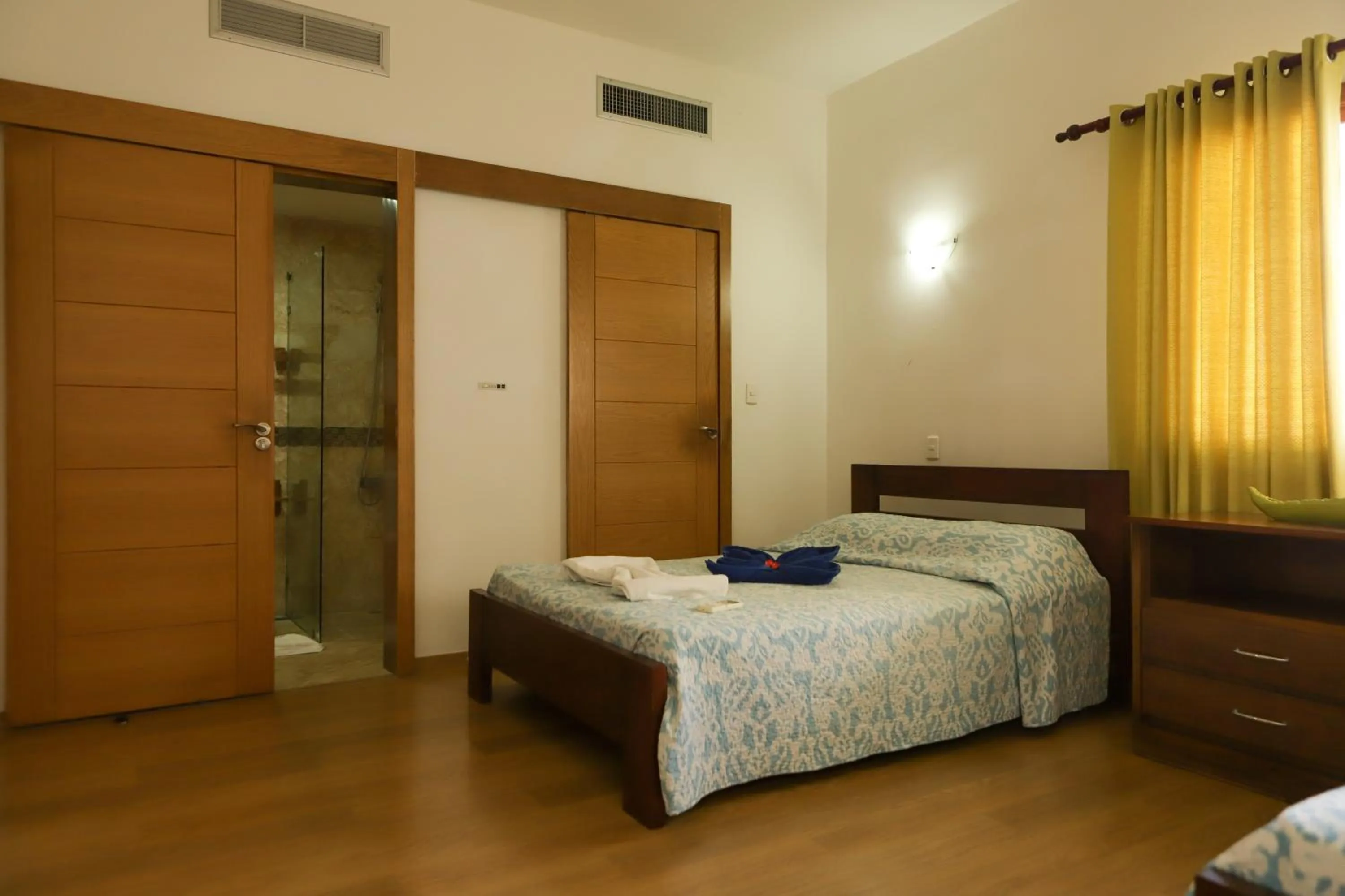 Bed in Sybaris Suites & Residences