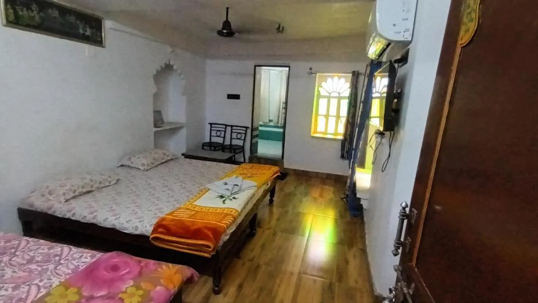 Photo of the whole room, Bed in Jag Niwas Guest House & pure veg restaurant