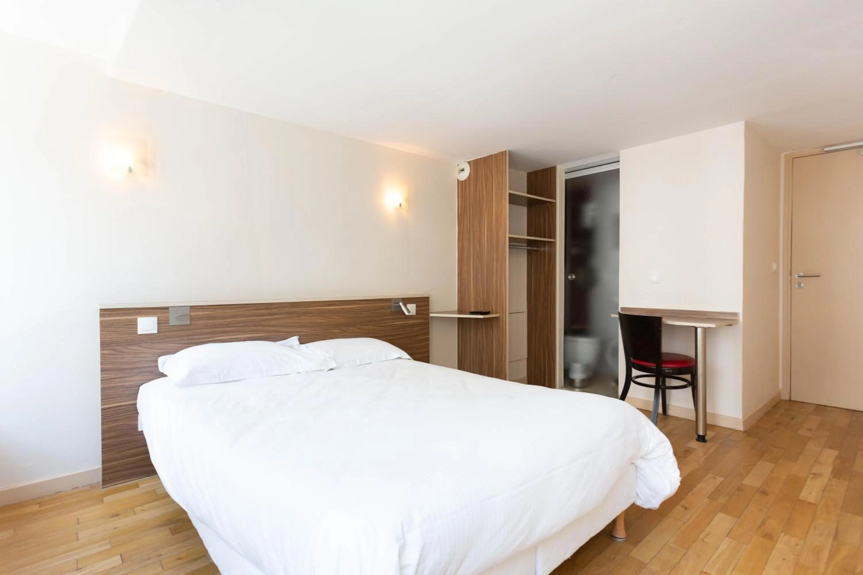 Bed in Hotel Mimosa Paris