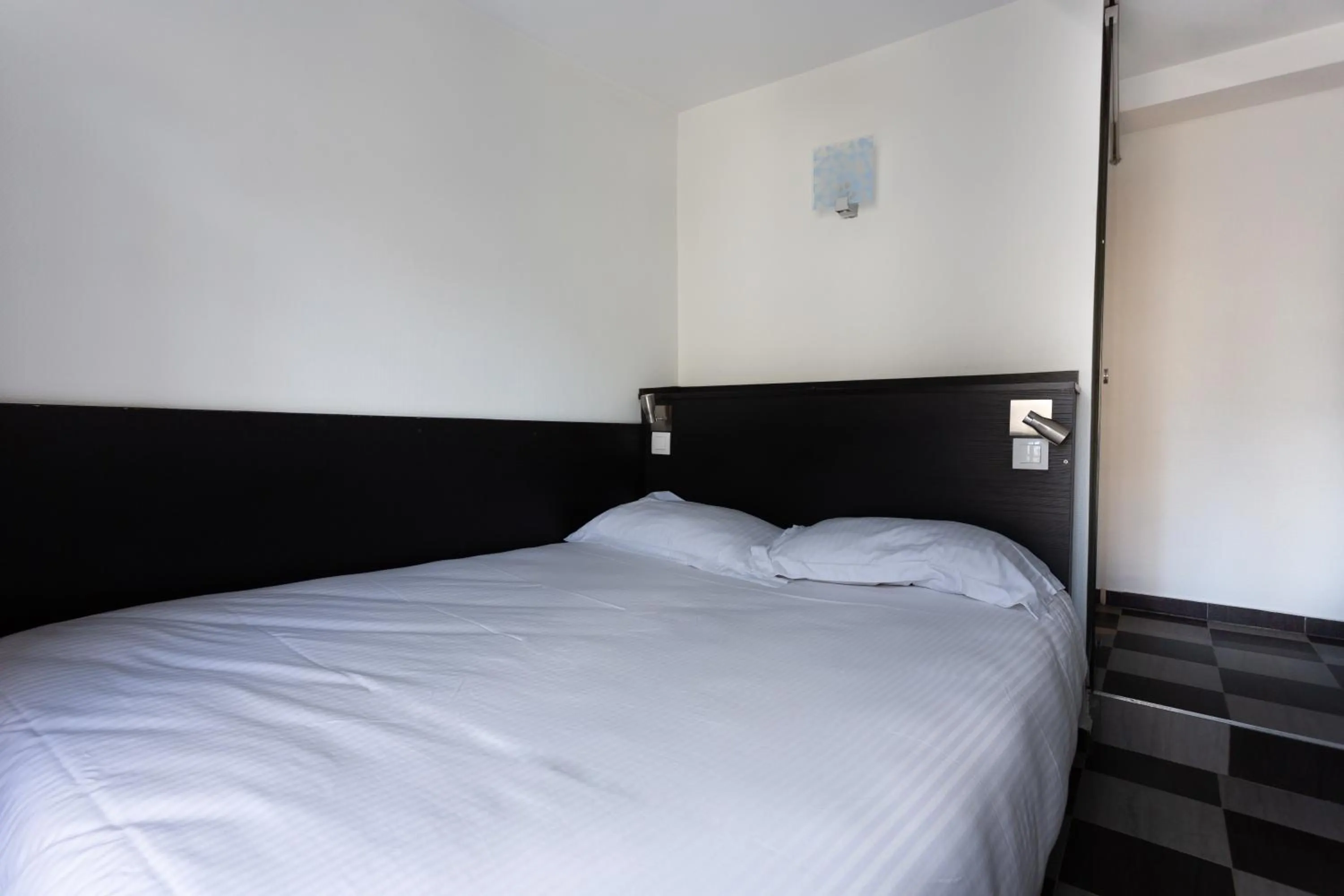 Bed in Hotel Mimosa Paris