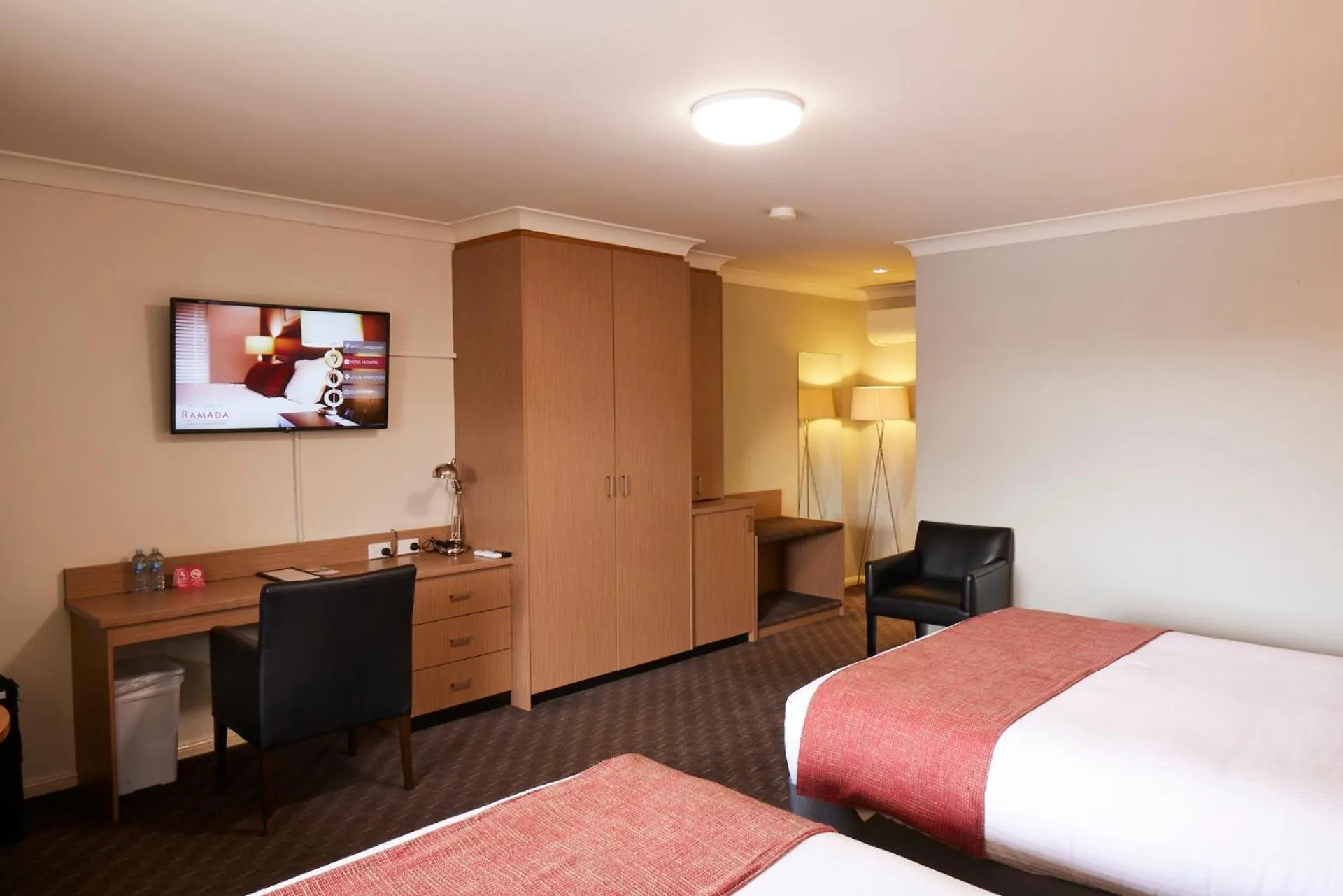 Communal lounge/ TV room, Bed in Ramada Hotel & Suites by Wyndham Cabramatta