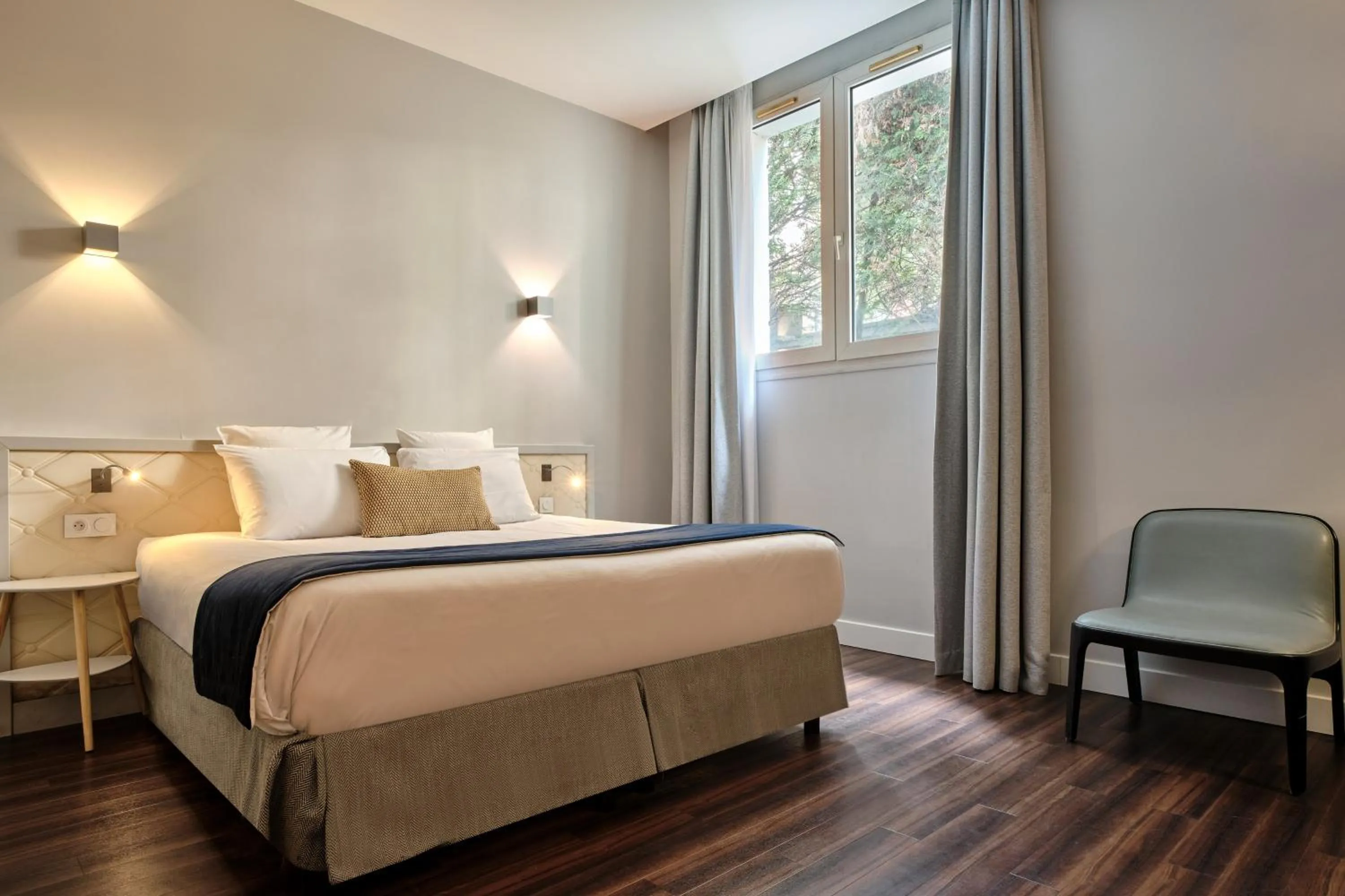 Bed in Hotel Atrium by Happyculture