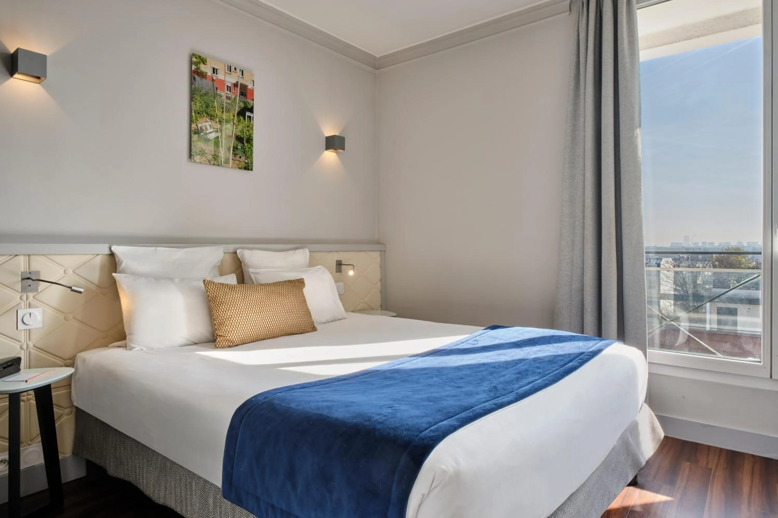 Bed in Hotel Atrium by Happyculture