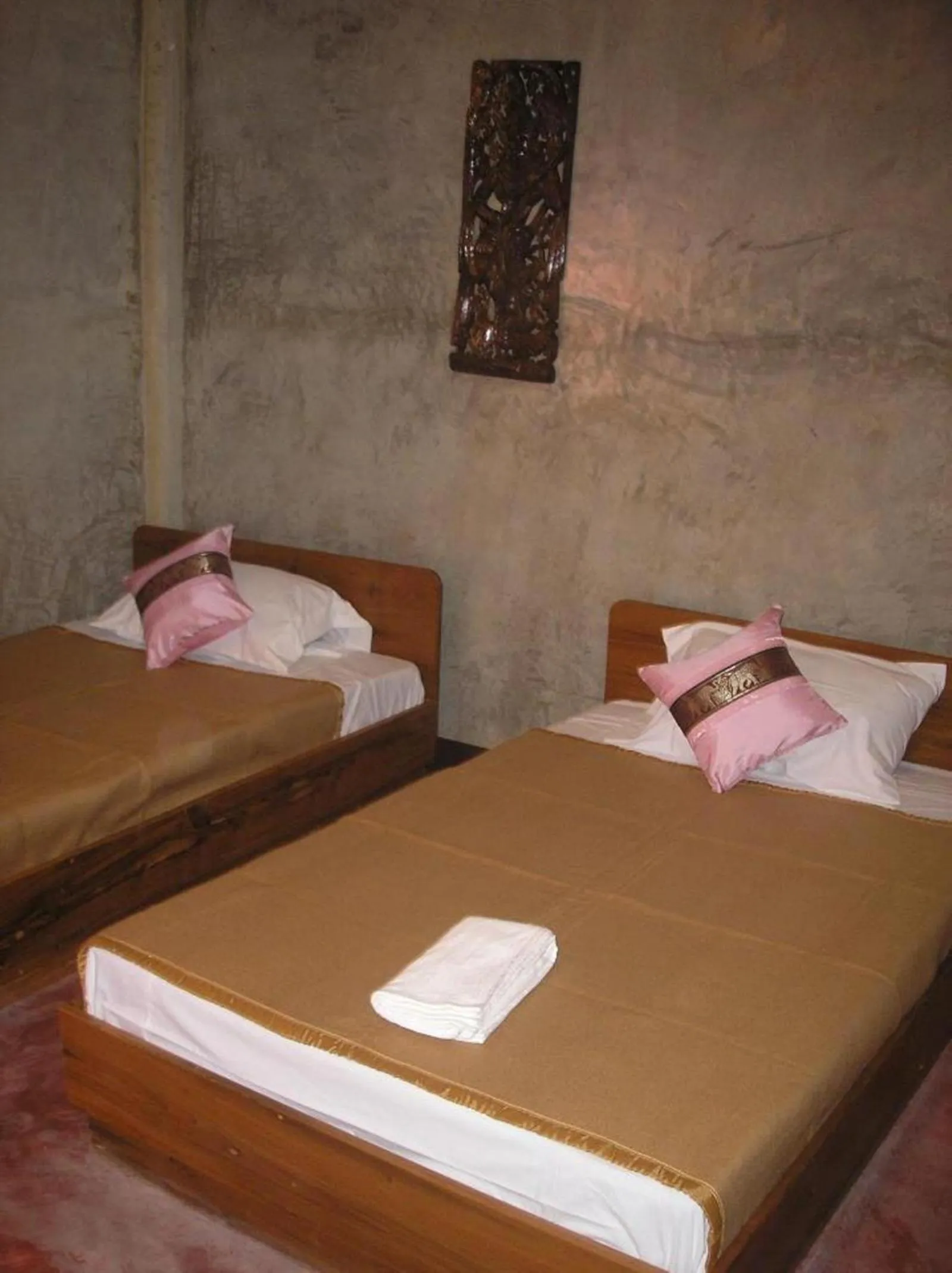 Bed in Tamarind Grand Resort Mae Sariang